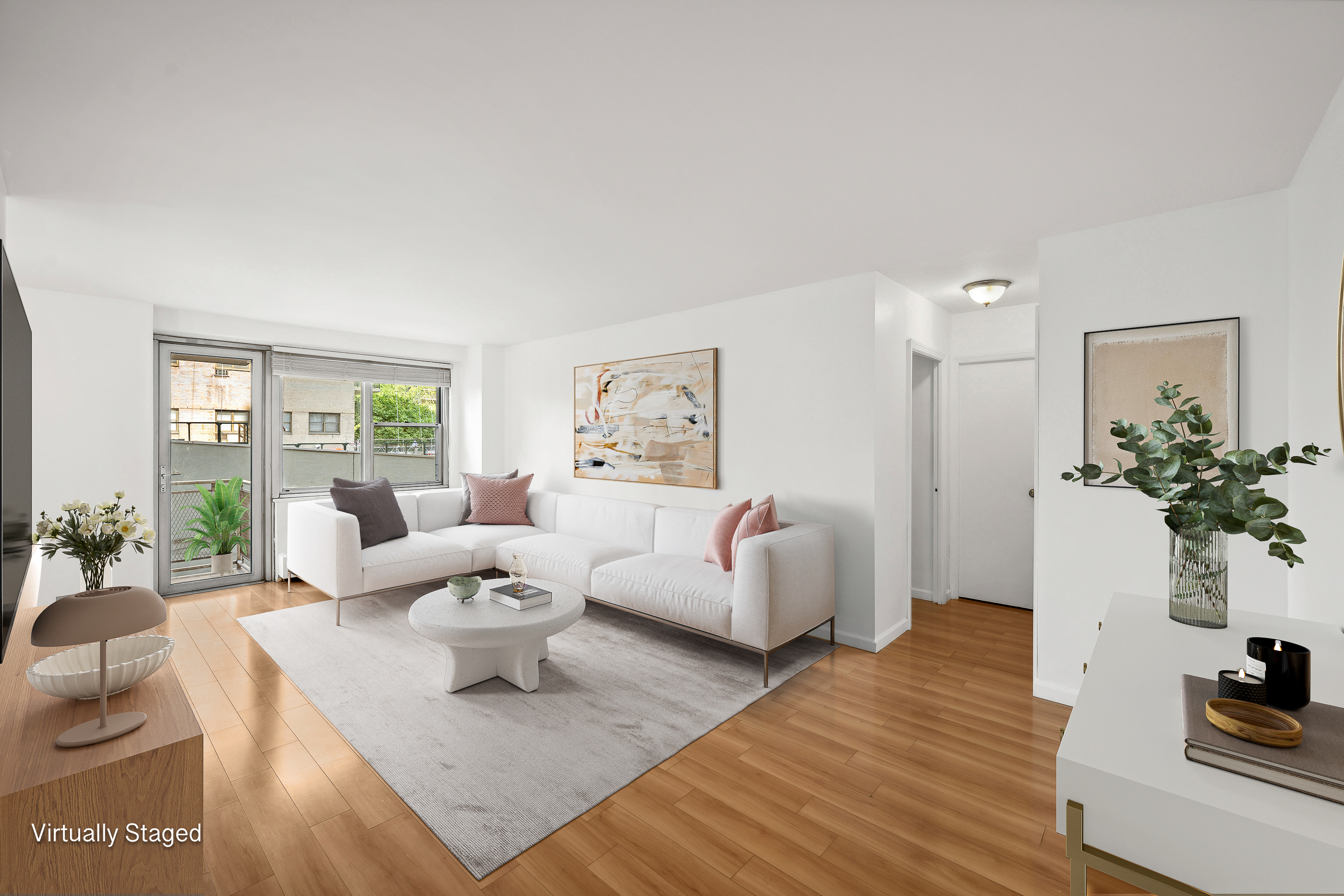 a living room with furniture and a wooden floor