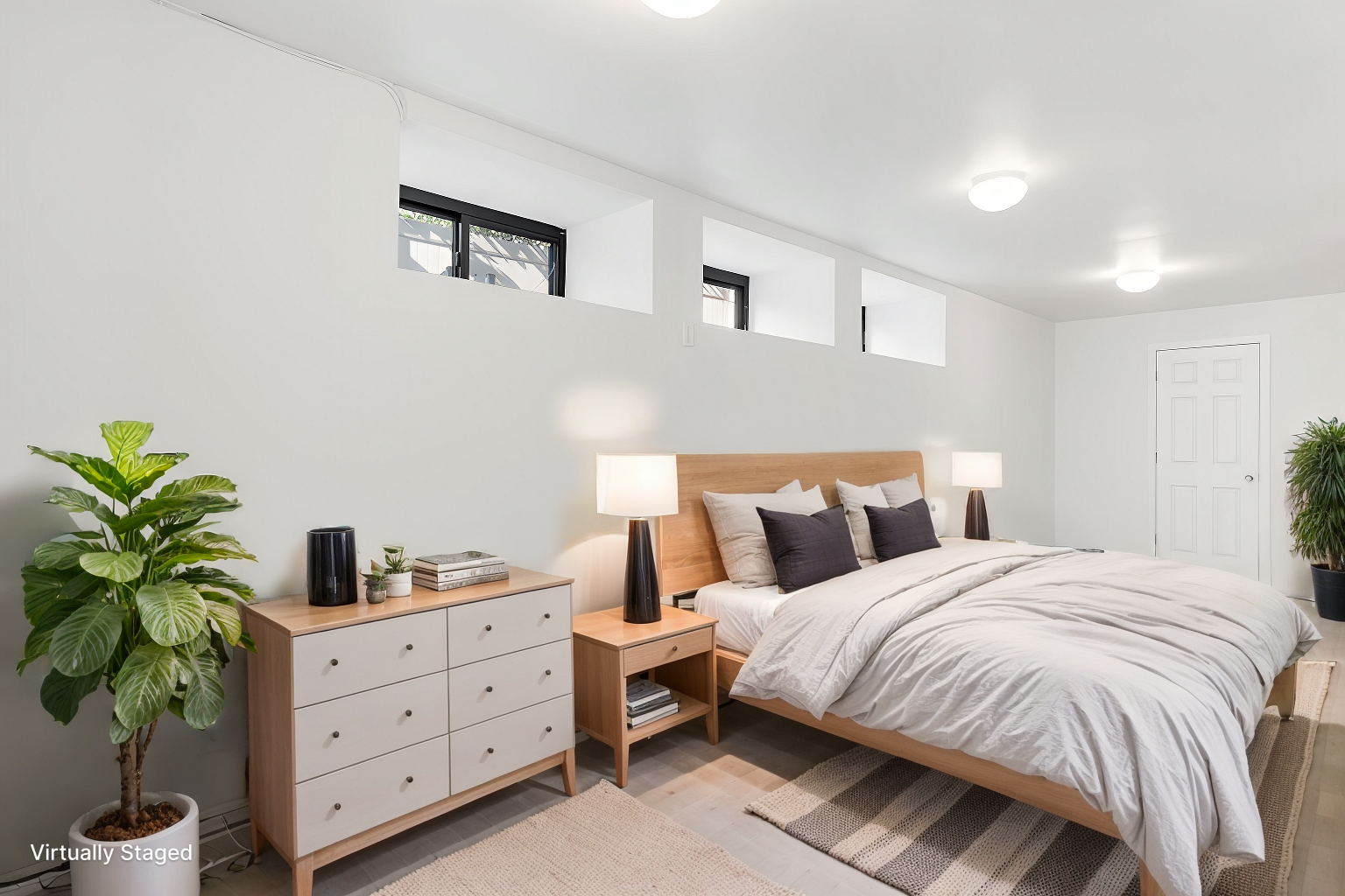 a bedroom with a bed and a potted plant