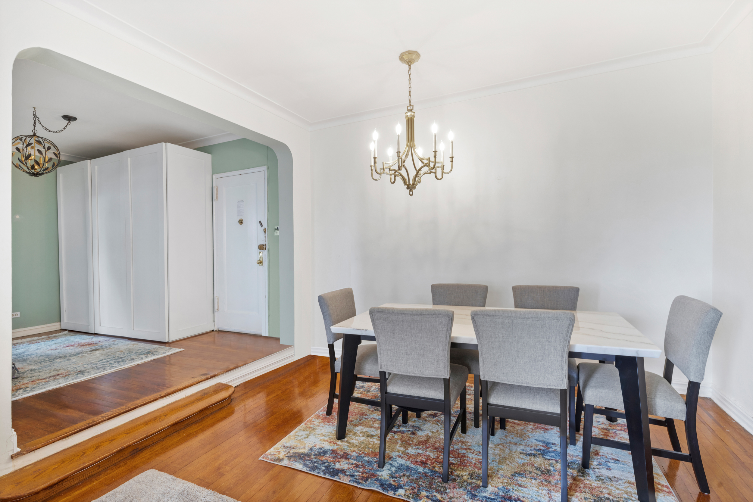 a view of a dining room with furniture and chandelier