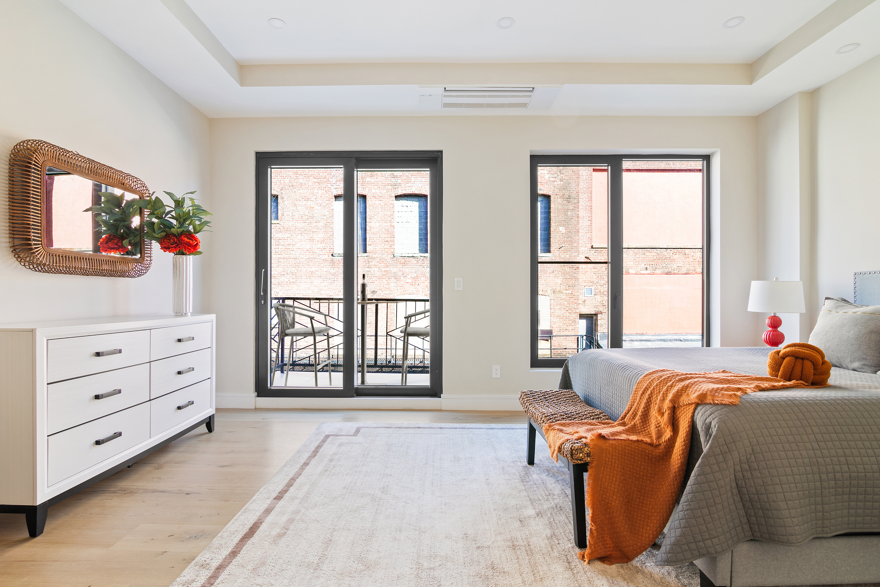 a living room with furniture and large windows