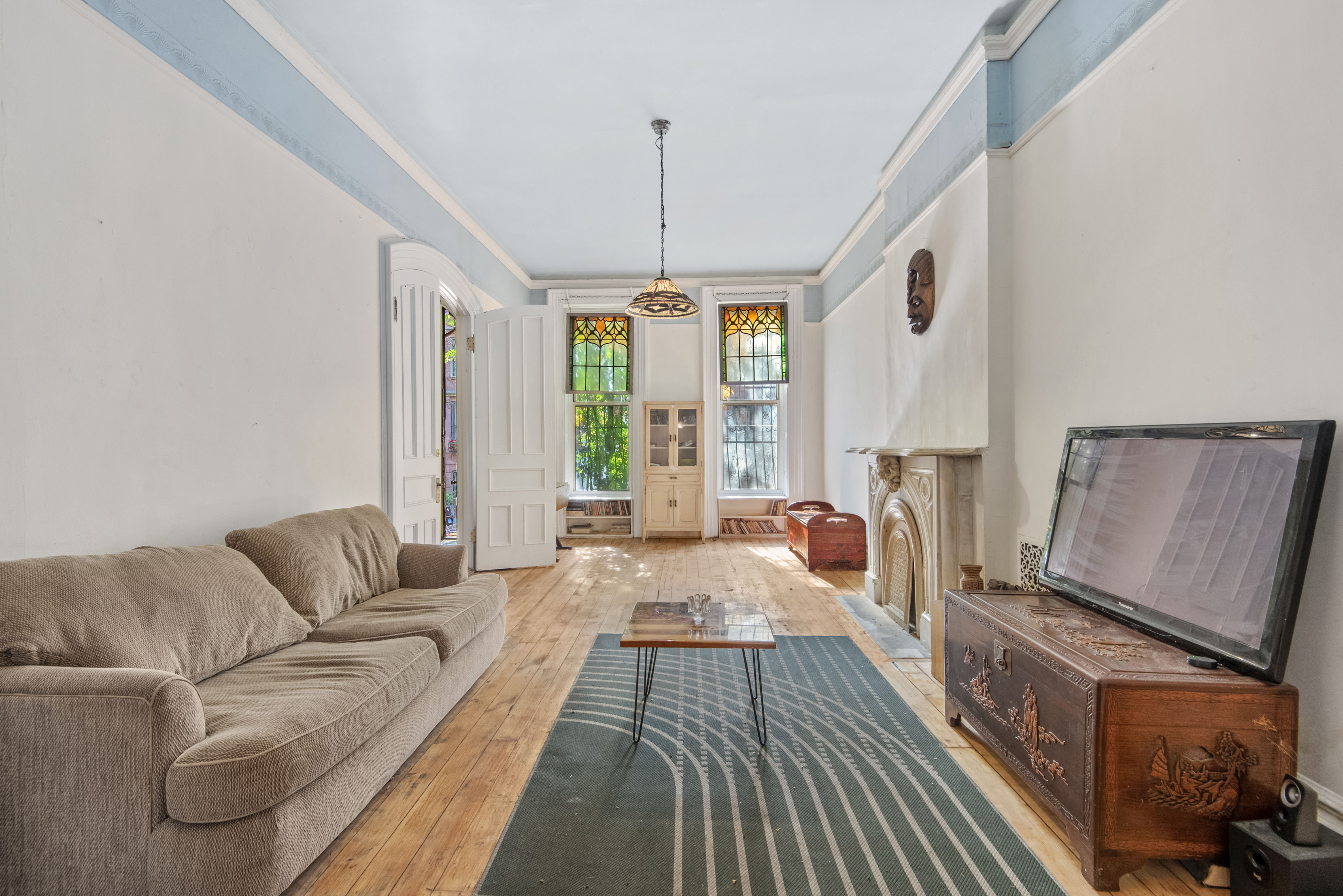 a living room with furniture and a chandelier