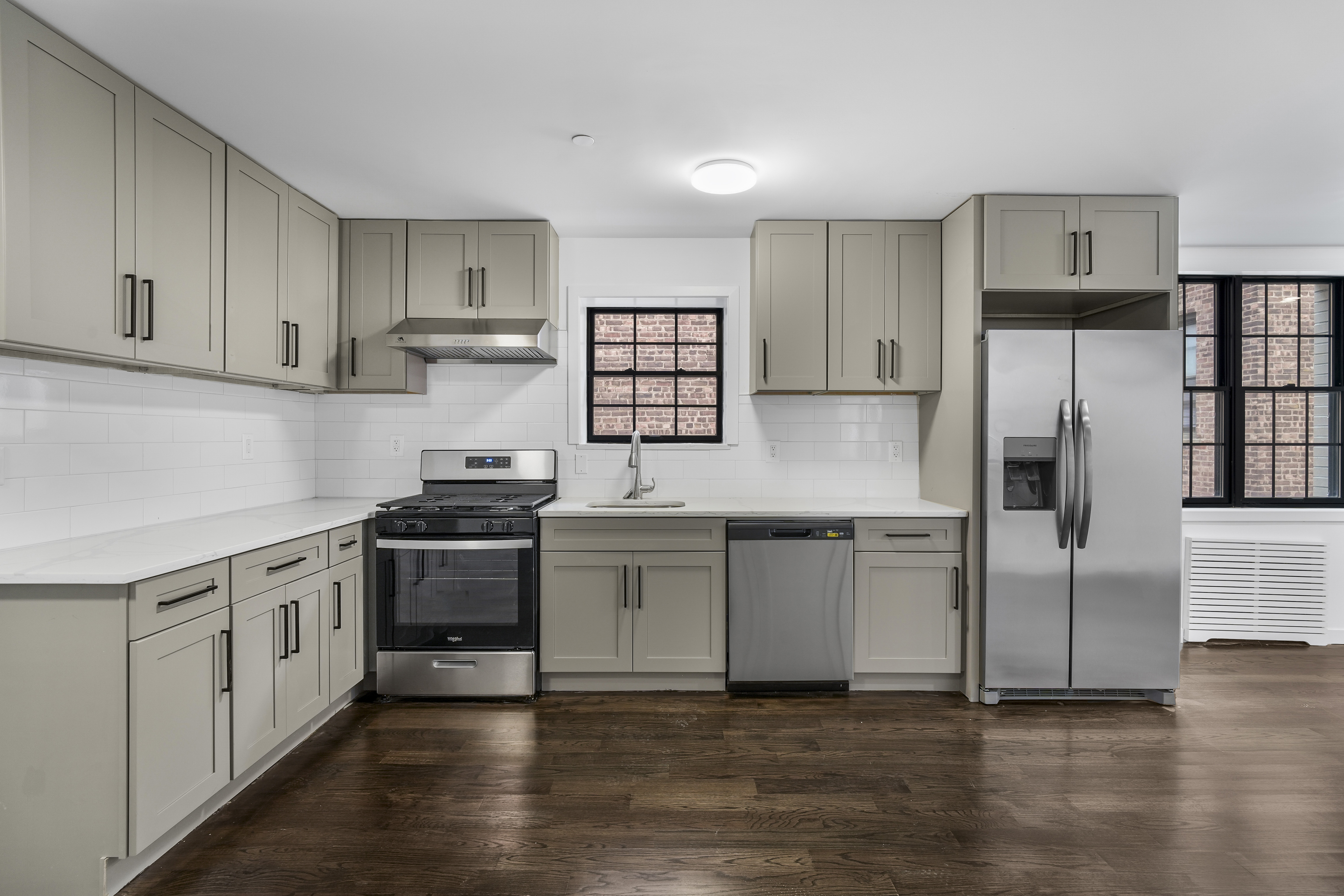 a kitchen with granite countertop white cabinets and stainless steel appliances