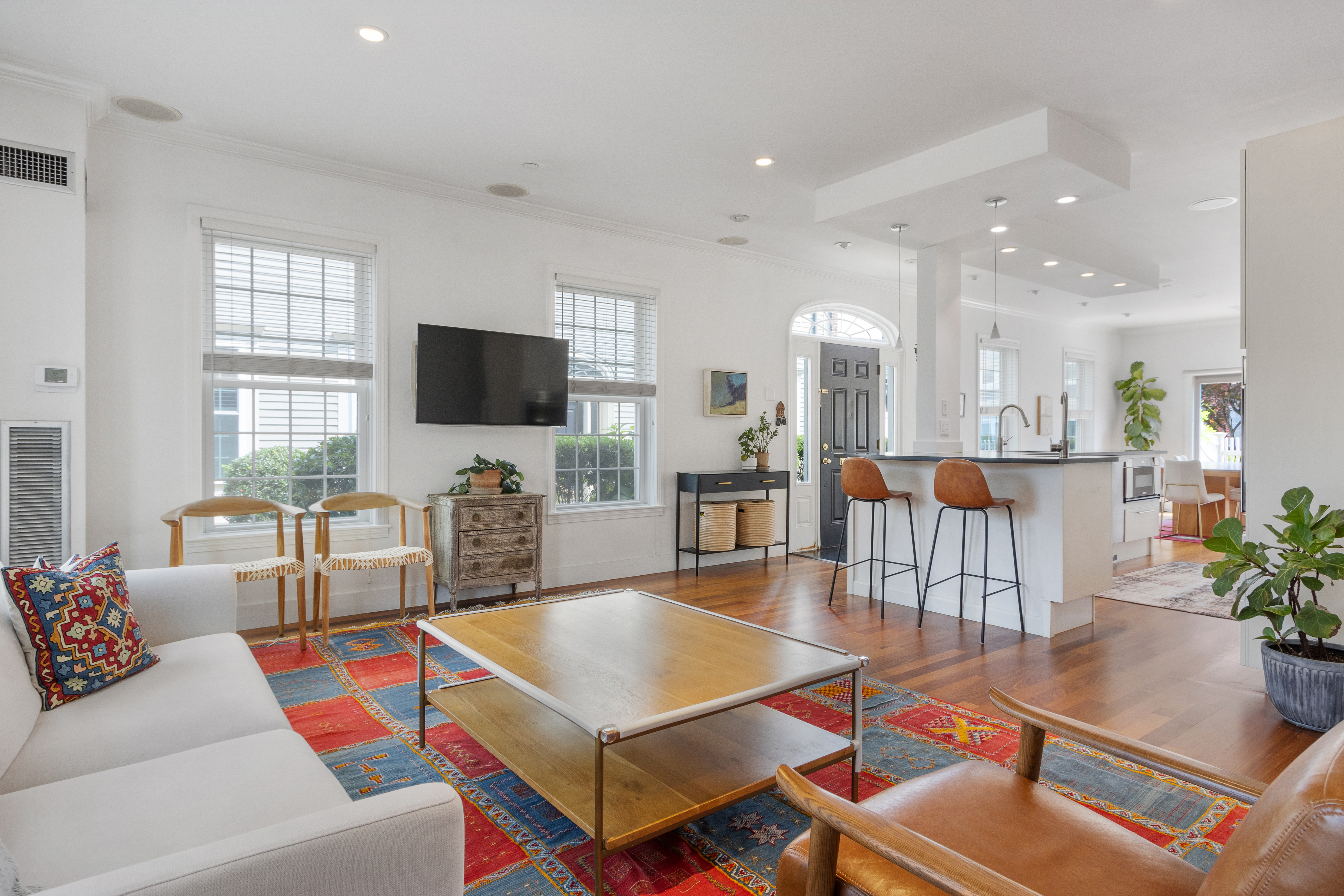 a living room with patio furniture and a flat screen tv