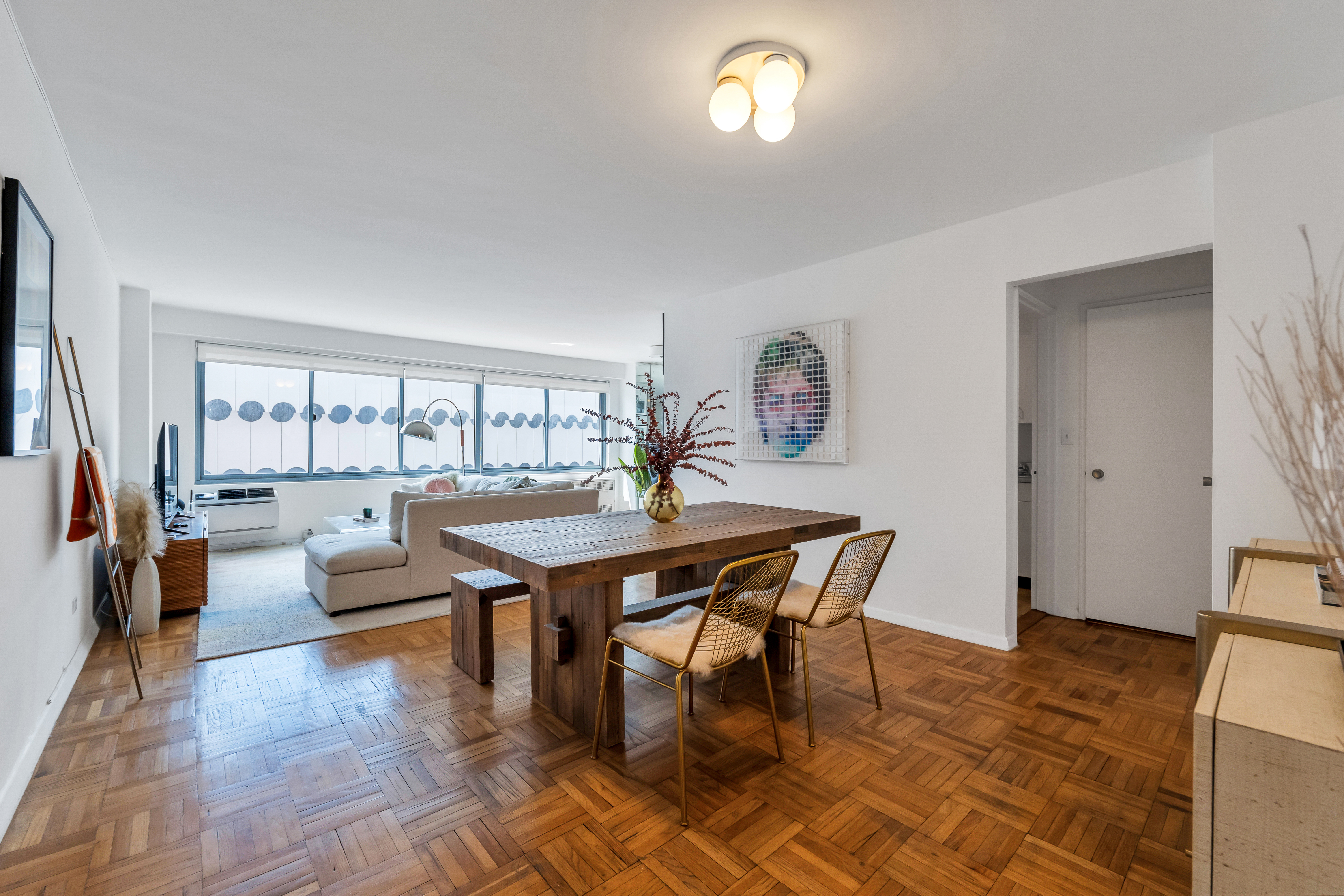 a dining room with furniture and wooden floor