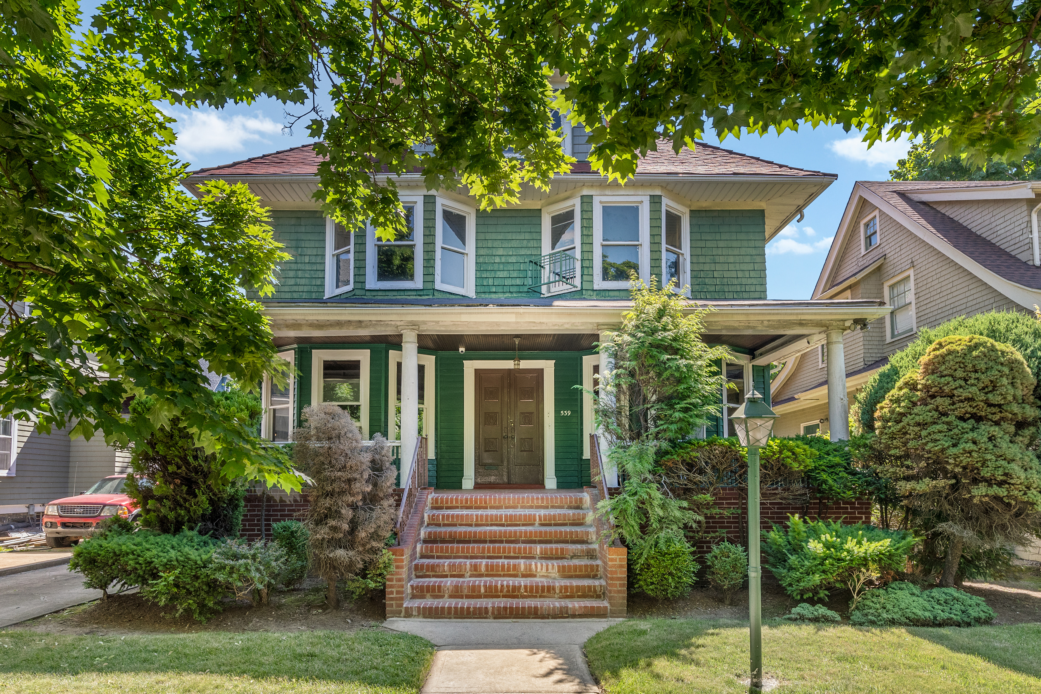 a front view of a house with garden