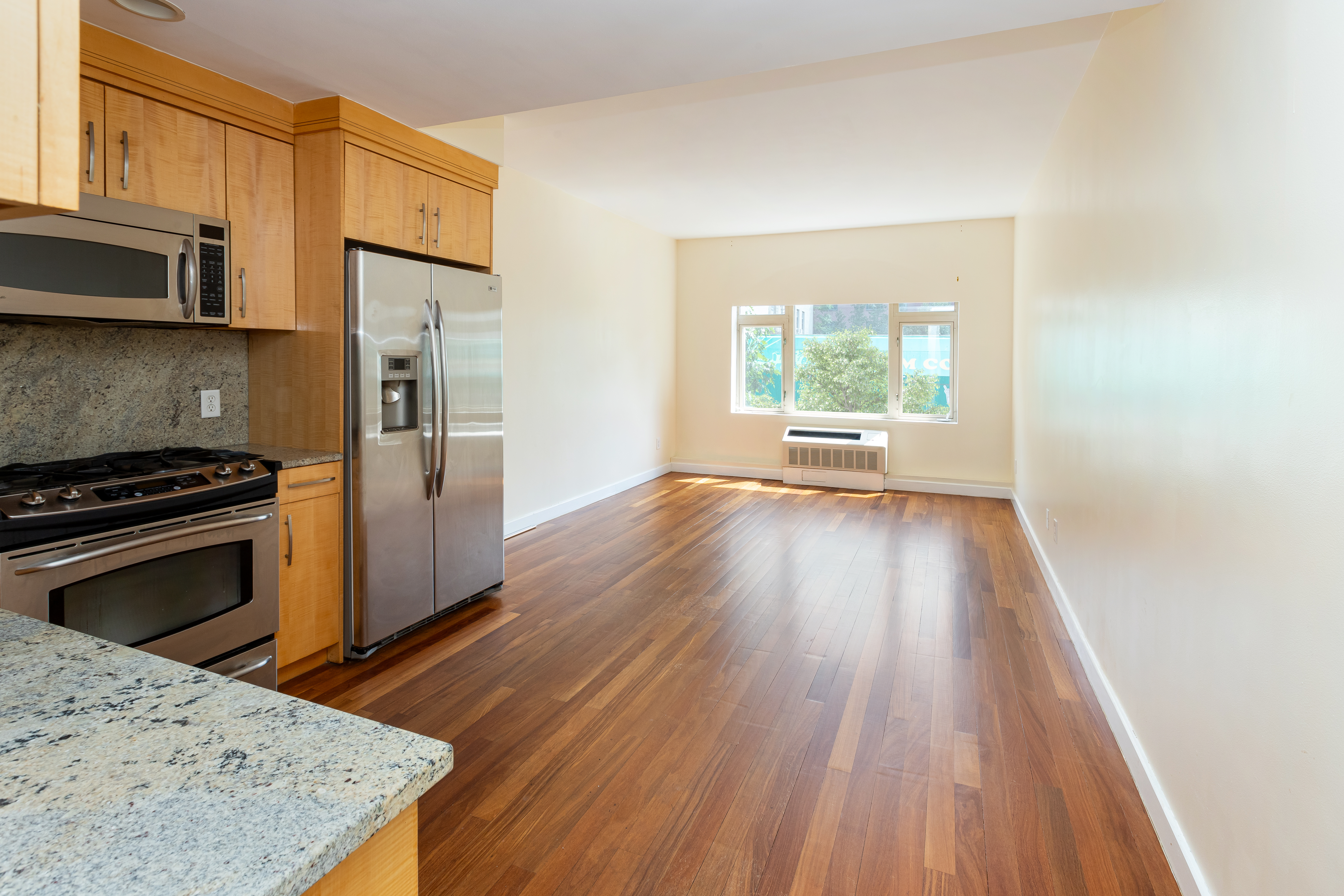 a kitchen with a wooden floor and a stove top oven