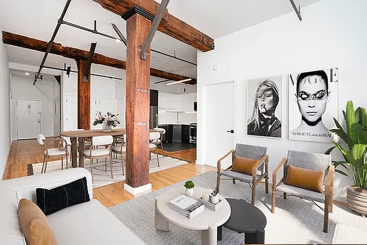 a living room with furniture a rug and white walls