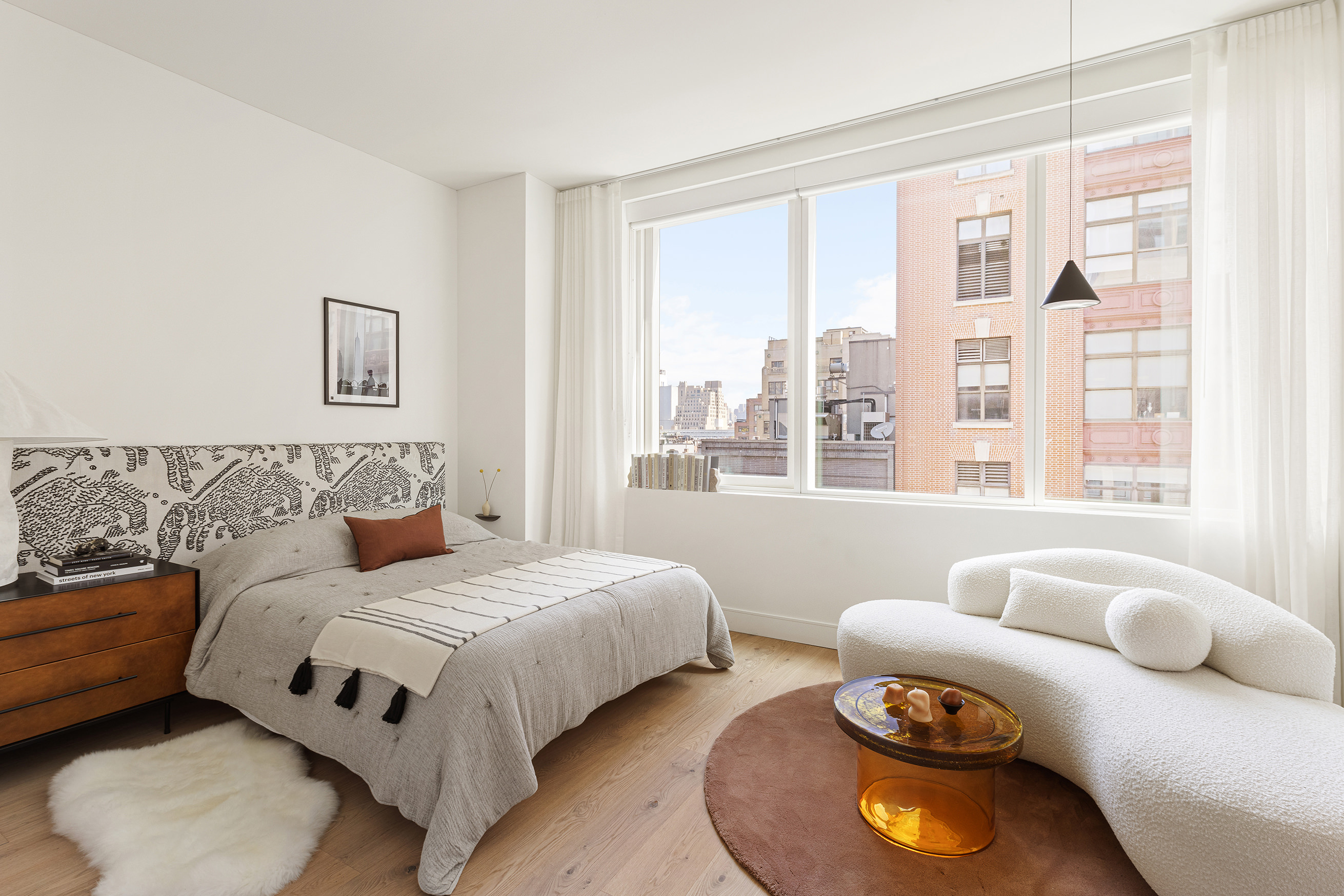 a bedroom with bed and a large window