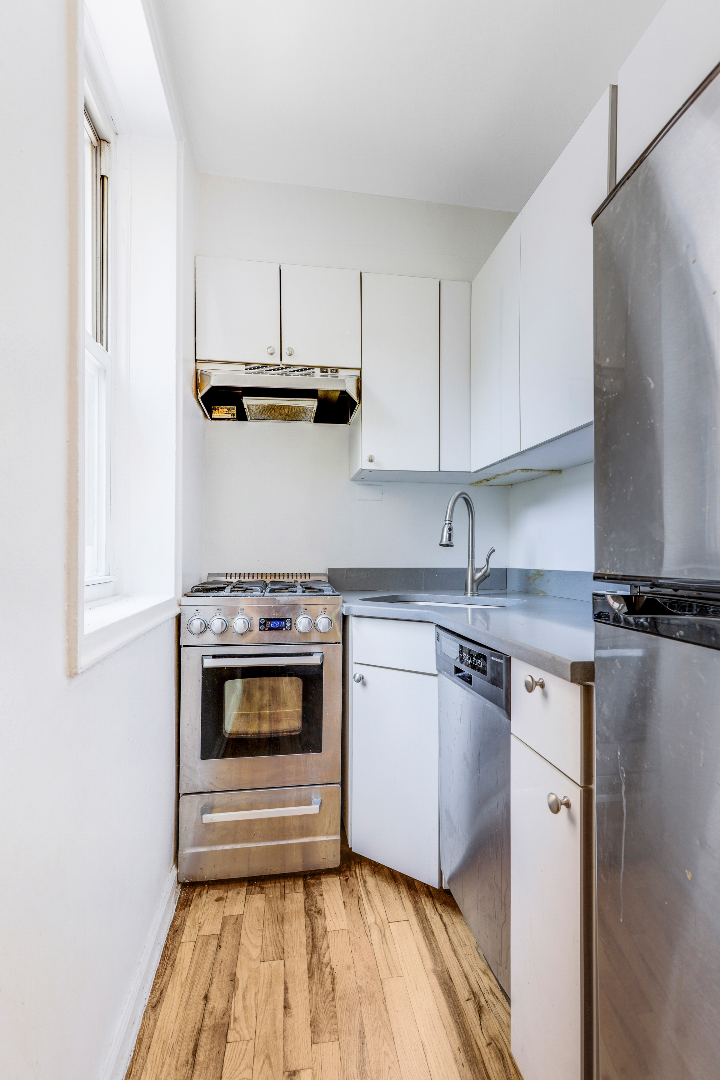 a kitchen with a stove and white cabinets