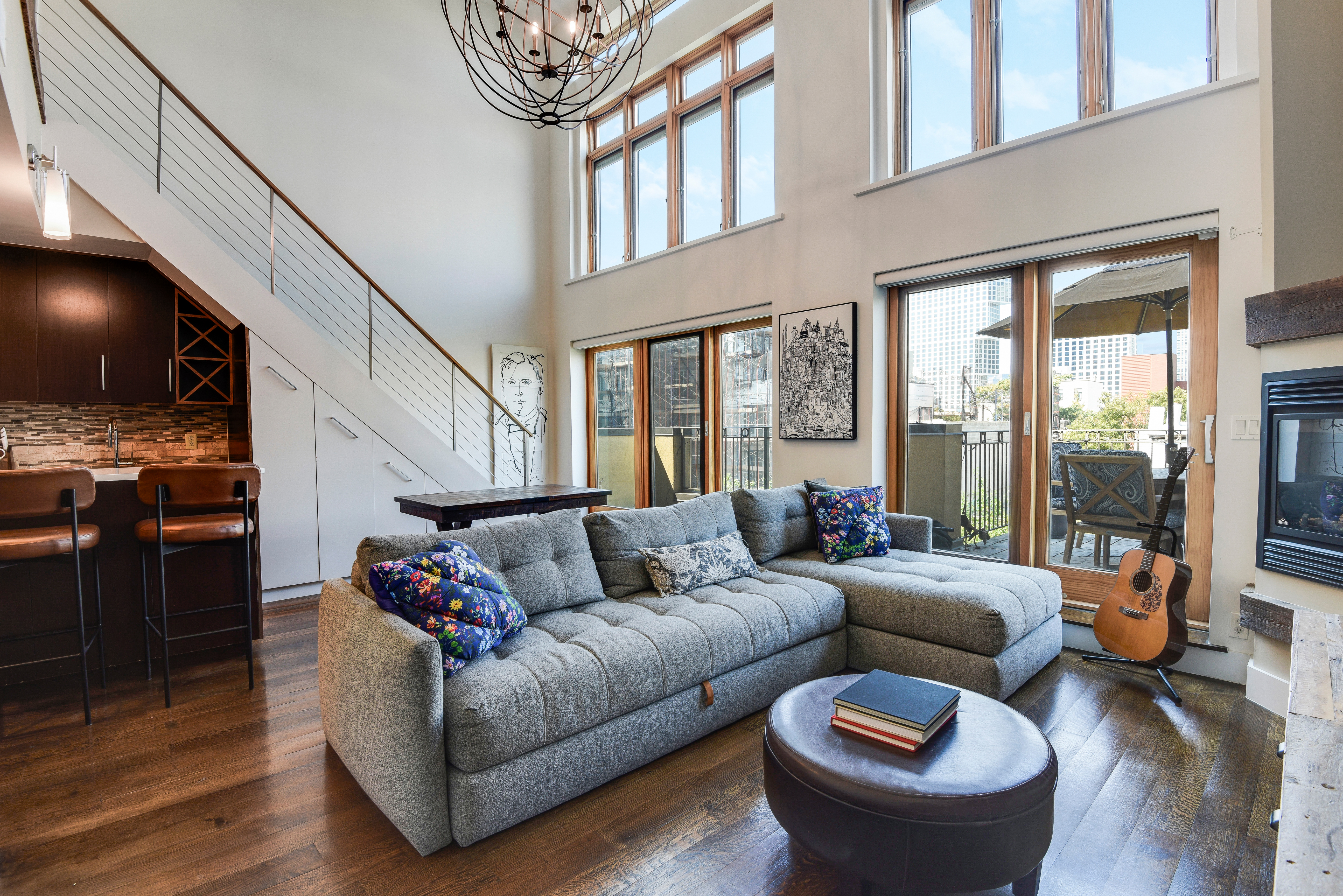 a living room with furniture a flat screen tv and a floor to ceiling window