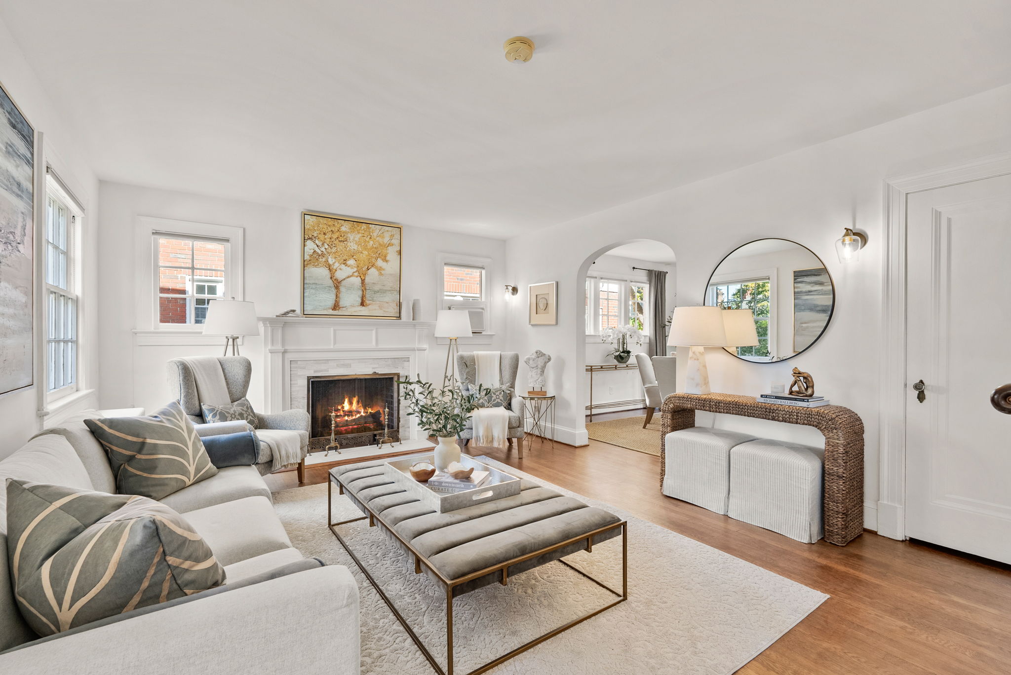 a living room with furniture a fireplace and a large window