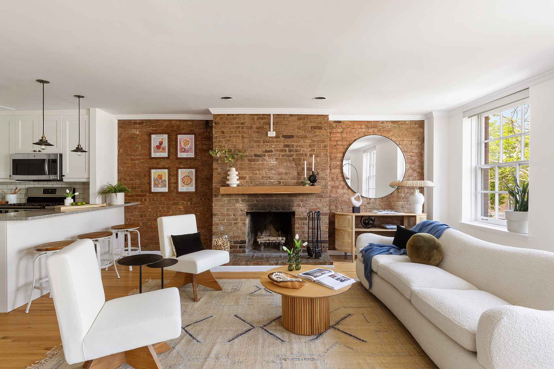 a living room with fireplace furniture and a large window