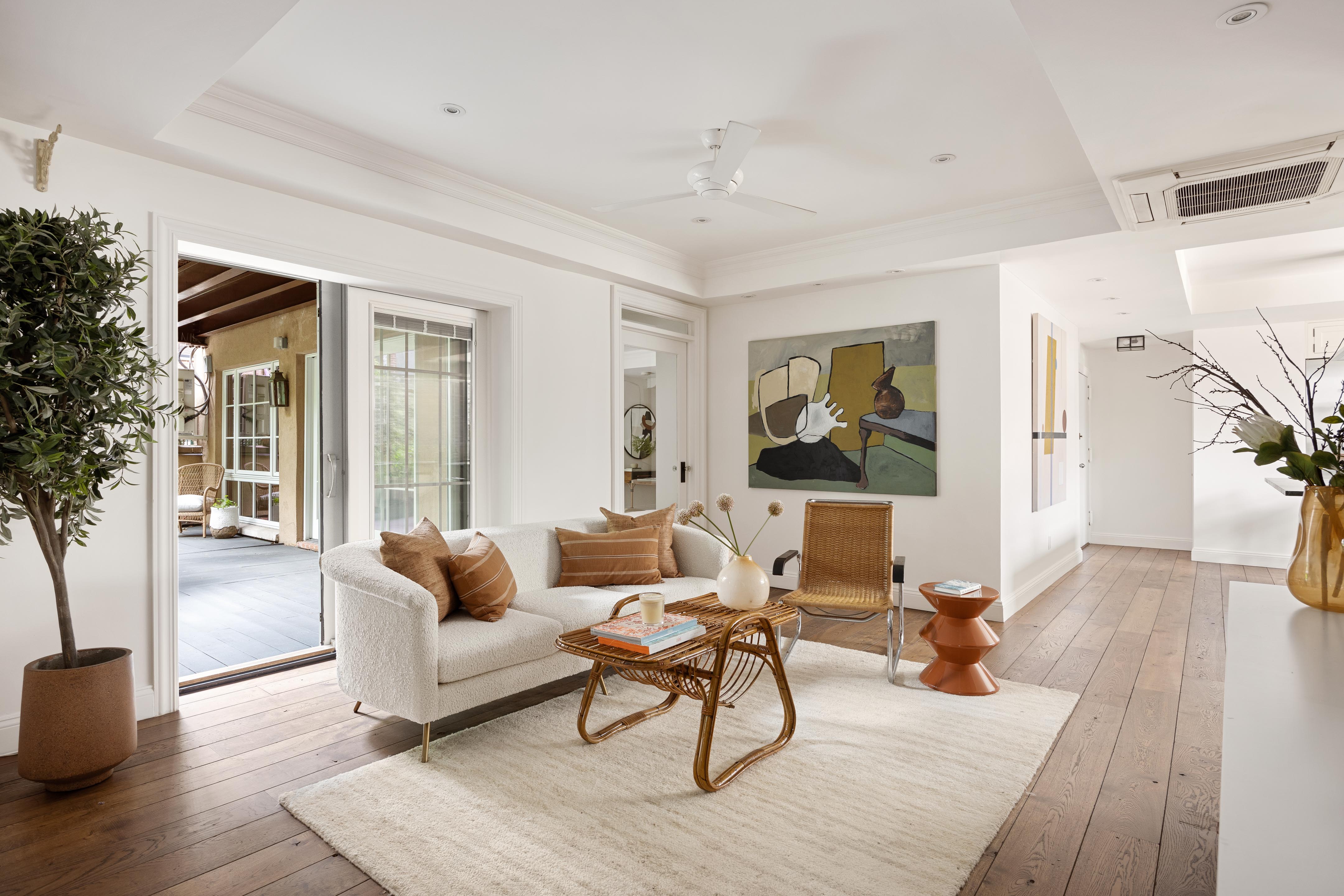 a living room with furniture and a wooden floor