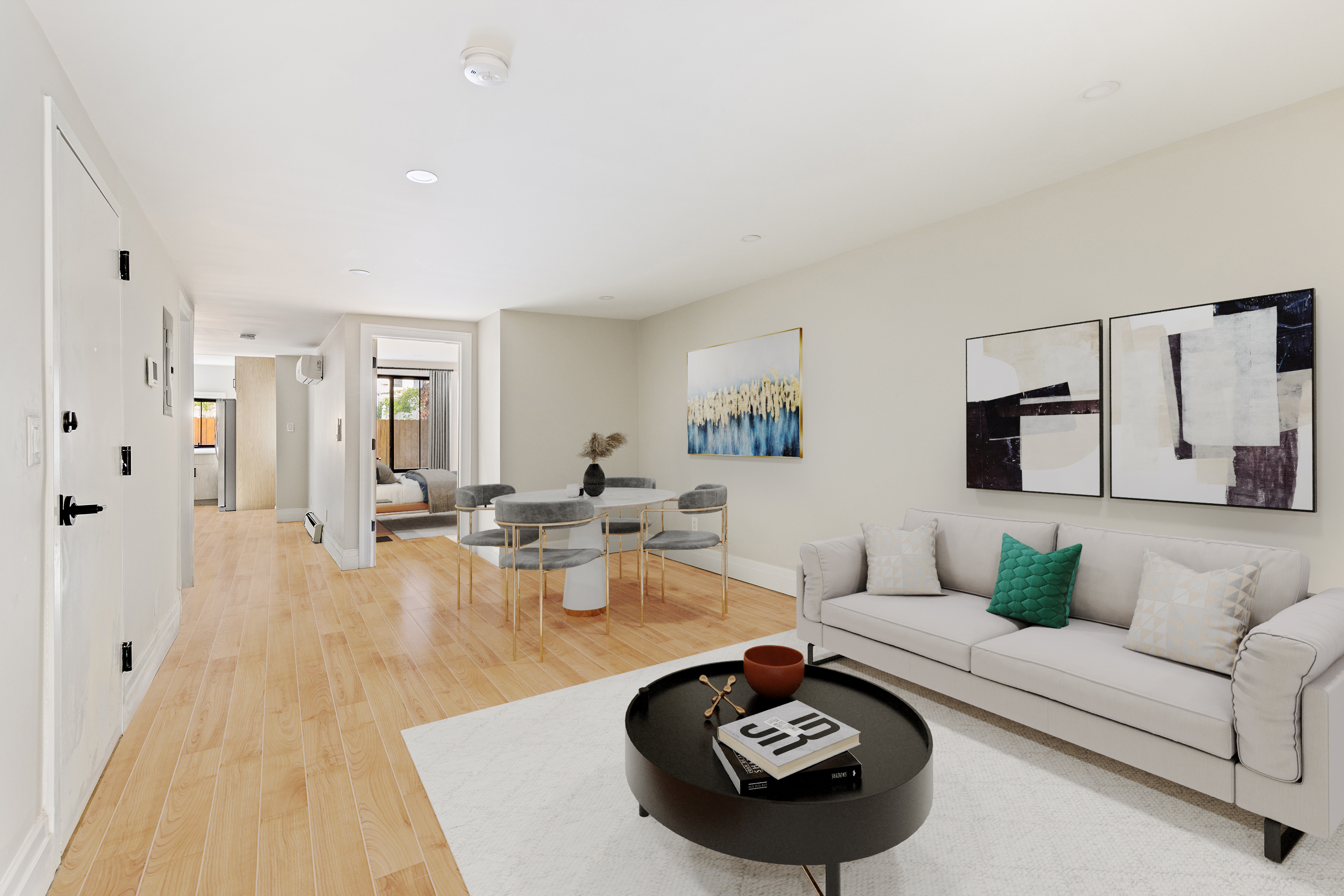 a living room with furniture and a wooden floor