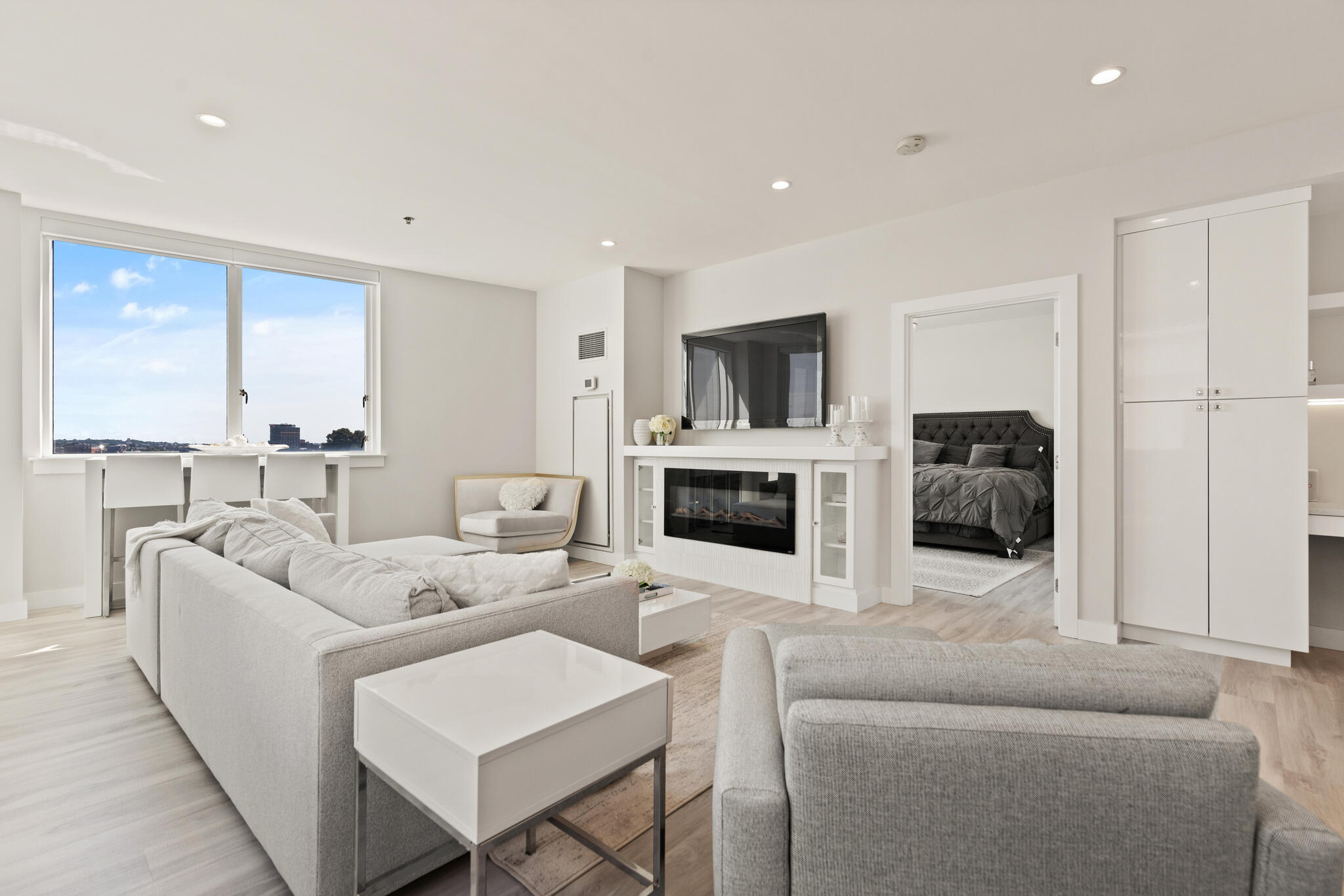 a living room with furniture a fireplace and a flat screen tv