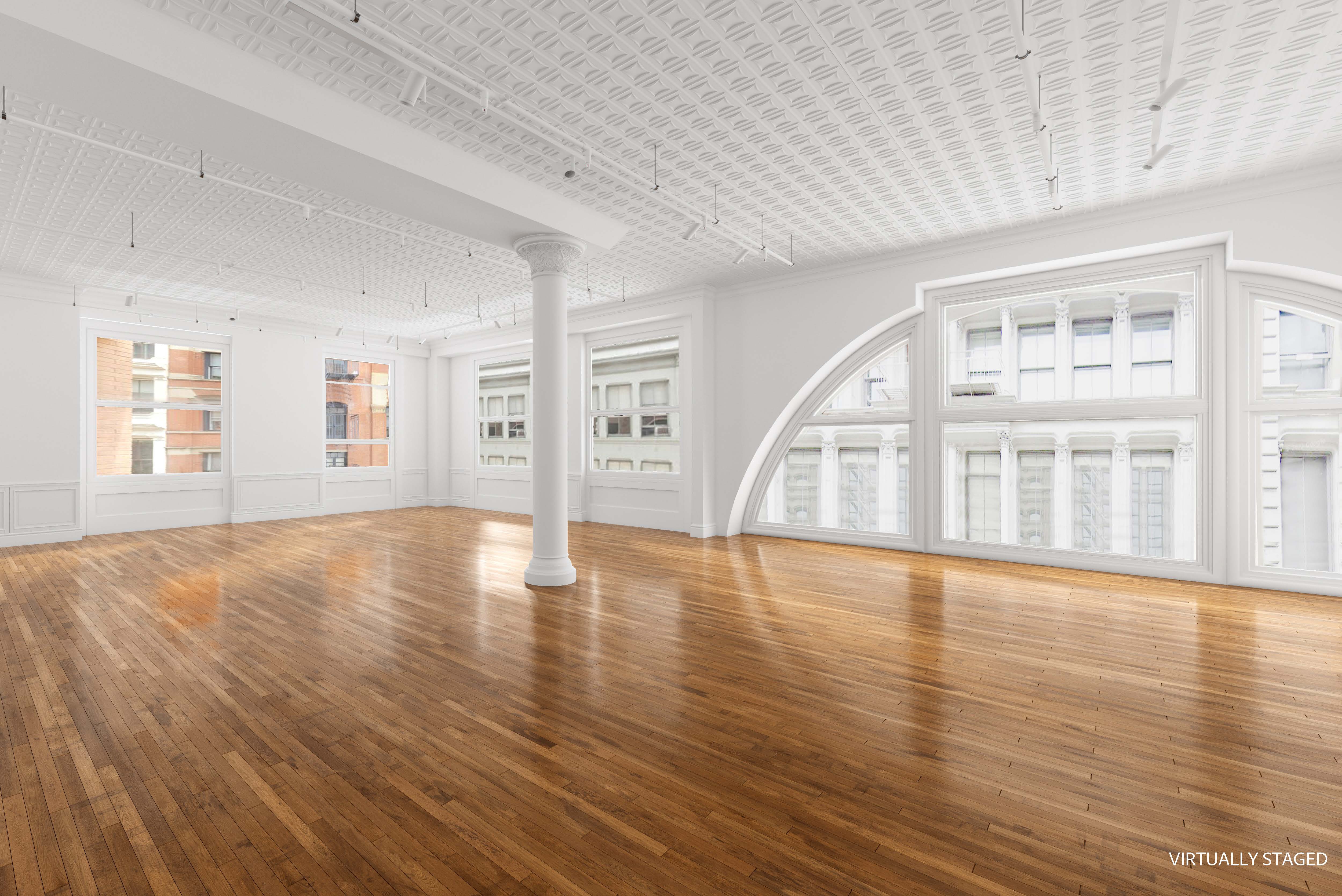 a view of empty room with wooden floor and windows