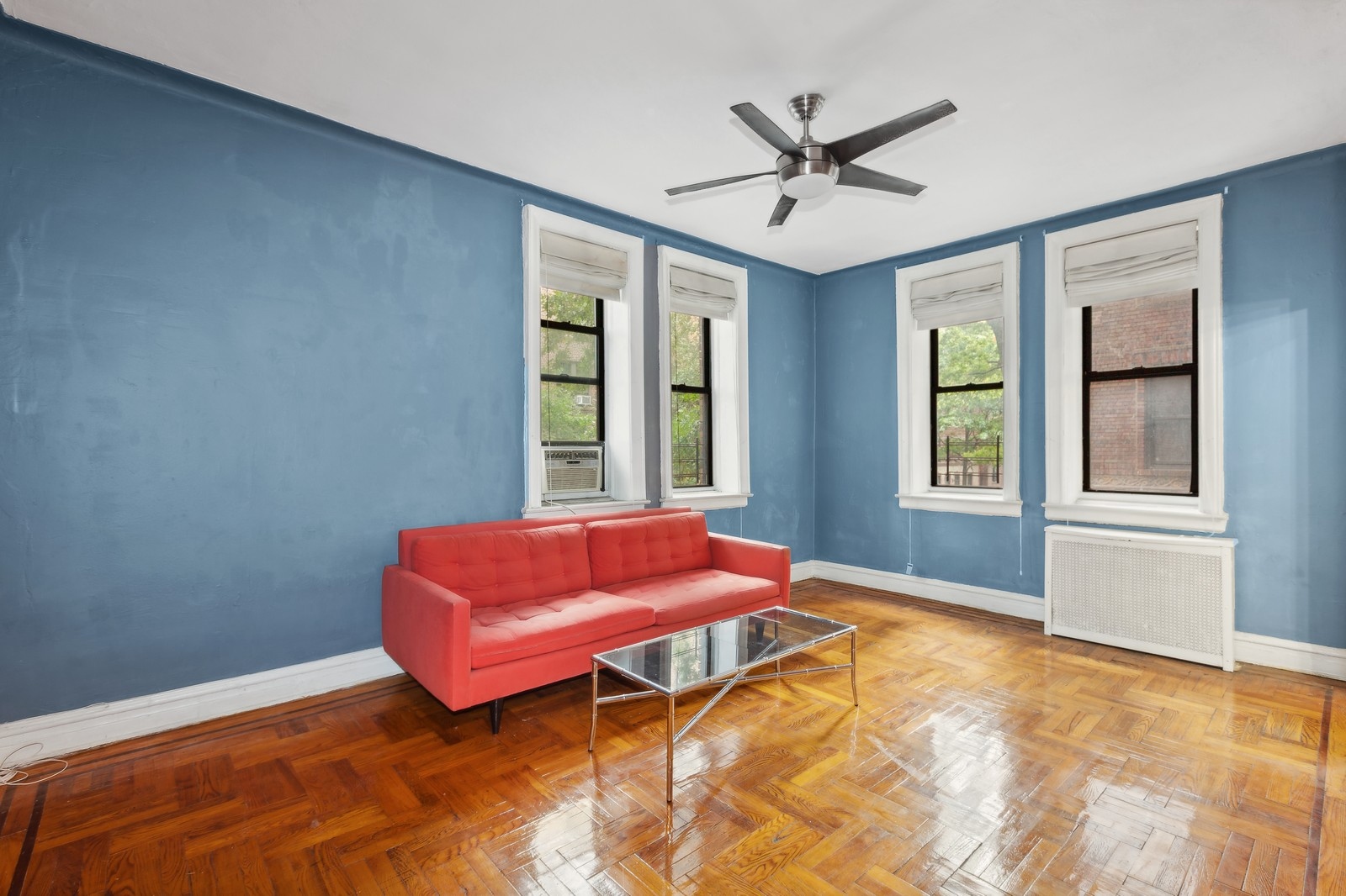 a blue bed sitting in a bedroom next to a window