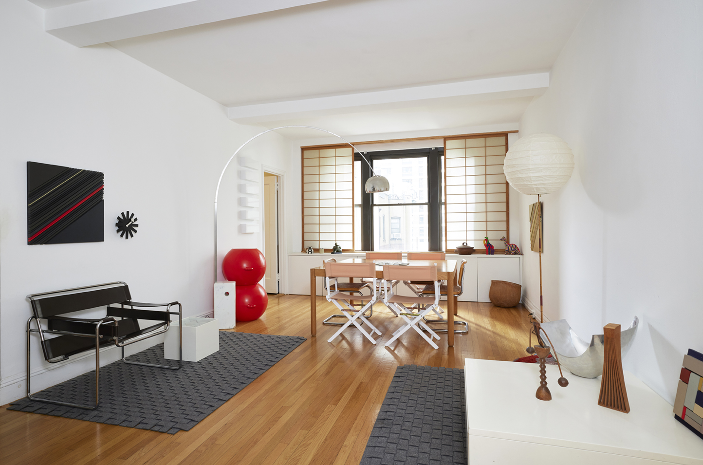 a living room with furniture a wooden floor and next to a window