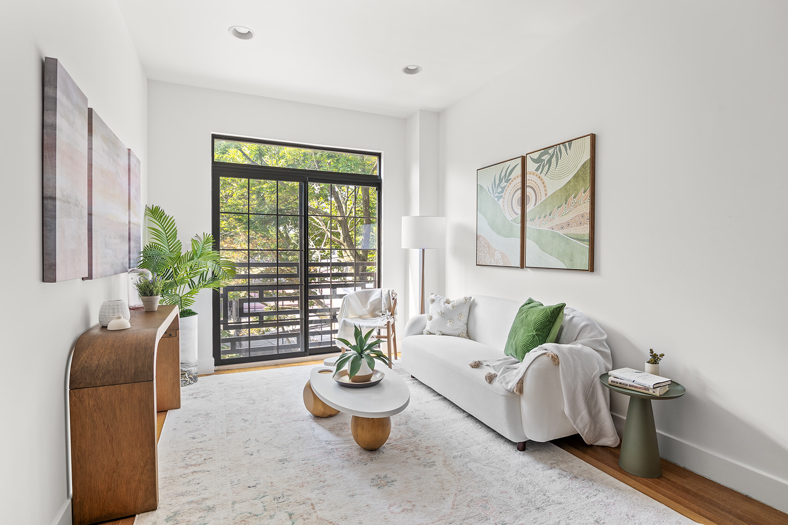 a living room with furniture and a potted plant