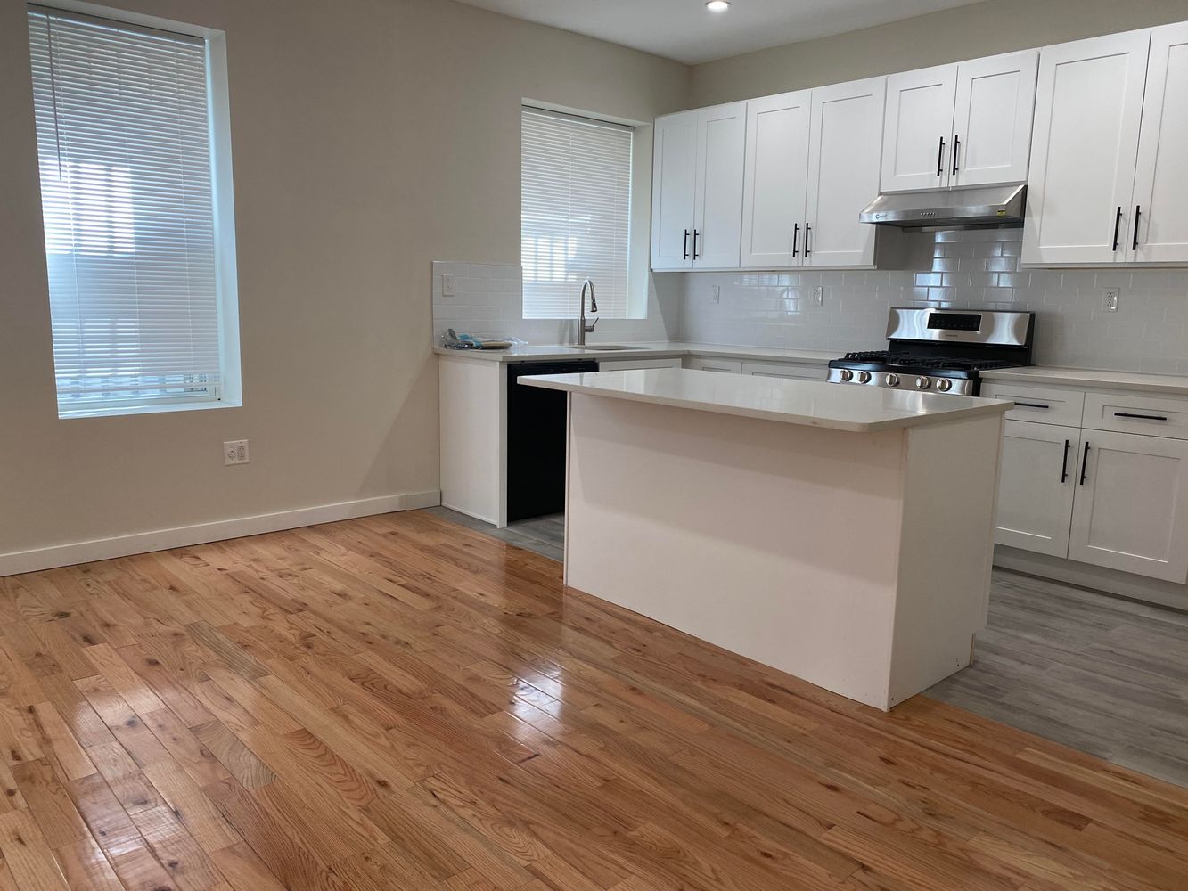 a kitchen with granite countertop a sink and cabinets