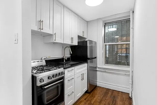 a kitchen with stainless steel appliances a stove a microwave and a refrigerator