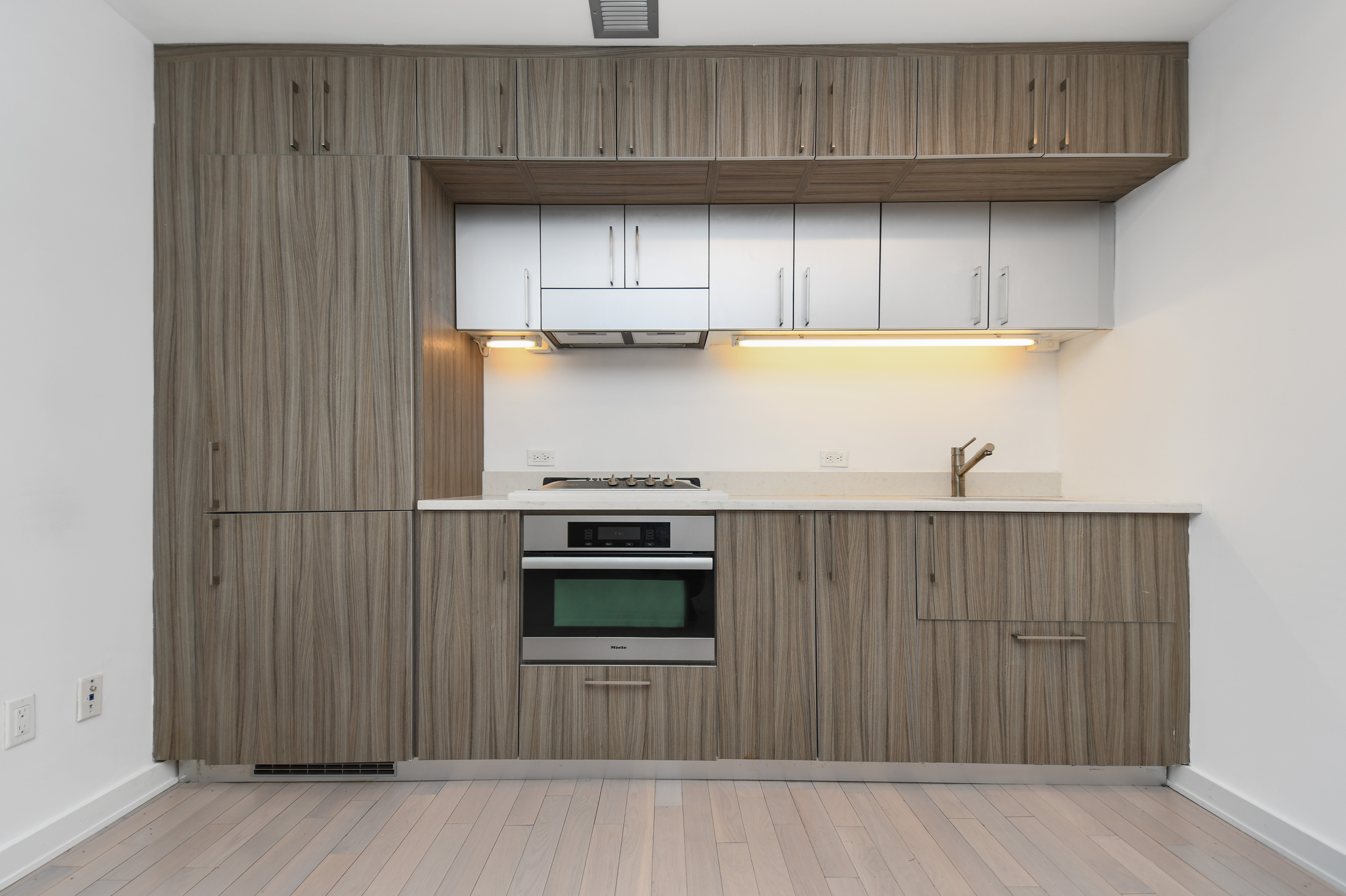 a kitchen with stainless steel appliances wooden cabinets and a stove top oven