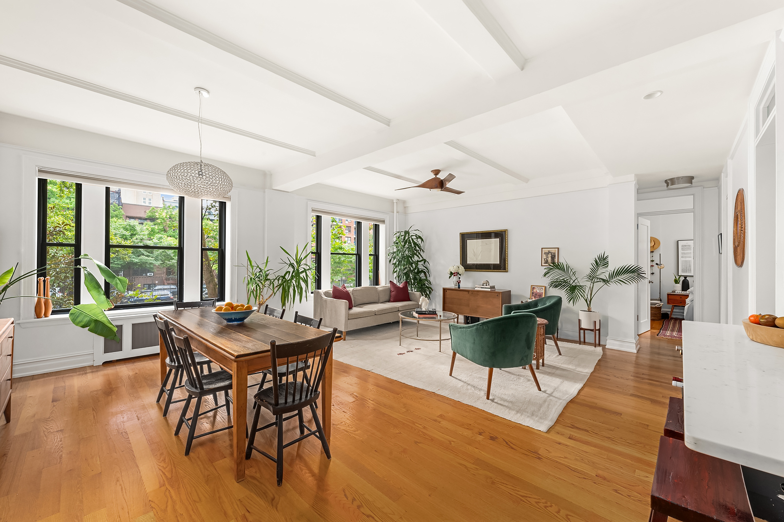 a living room with furniture a wooden floor and a large window