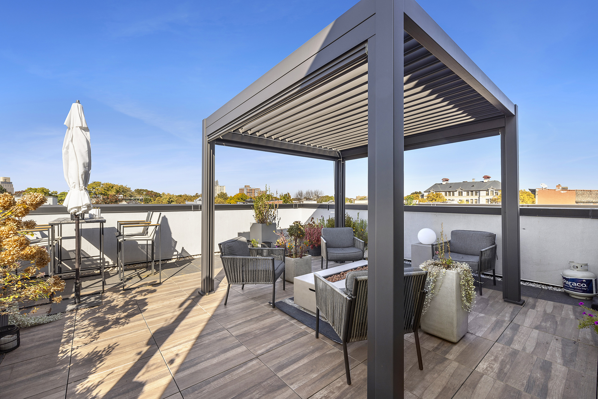 a balcony with wooden floor table and chairs