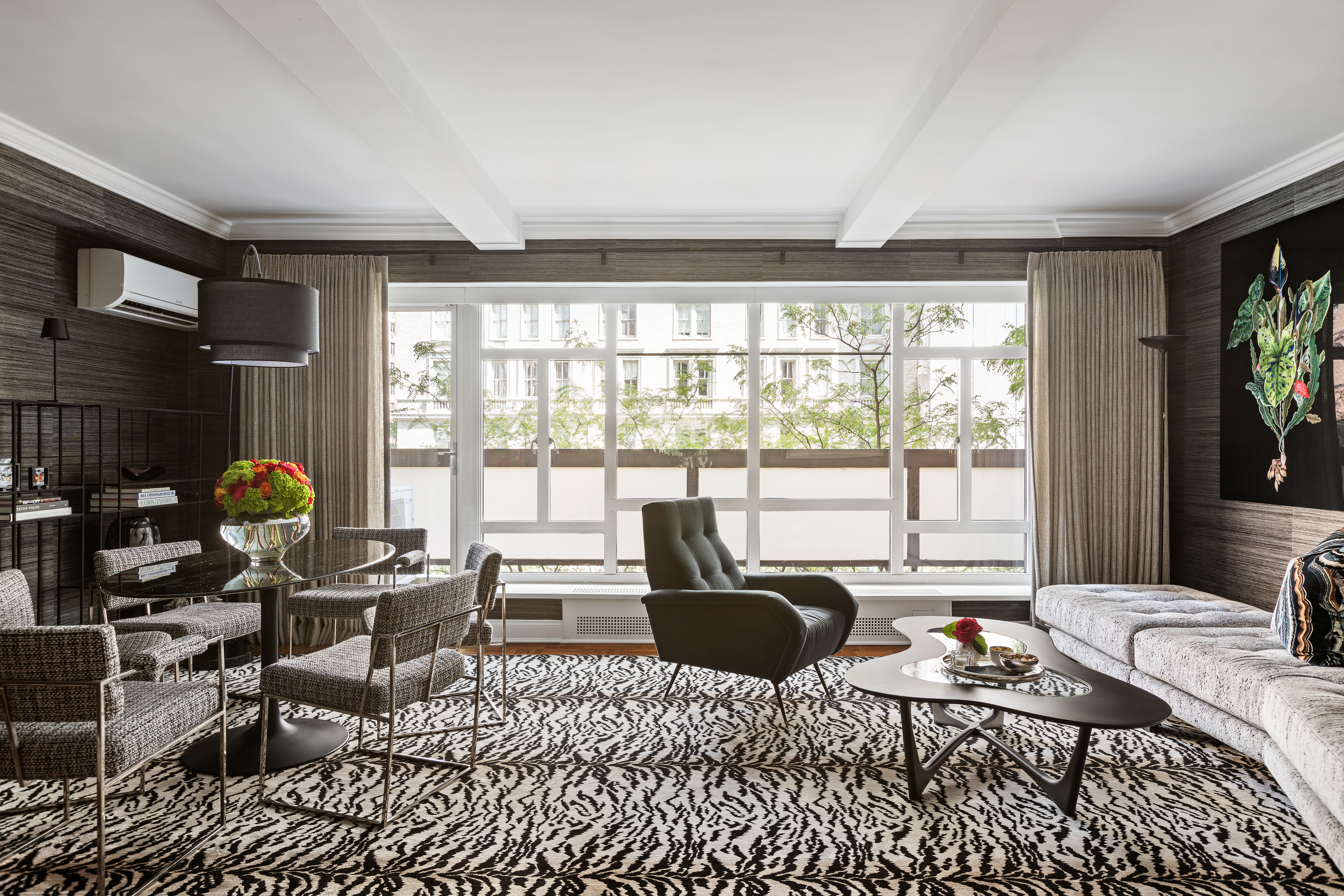 a living room with furniture and a floor to ceiling window