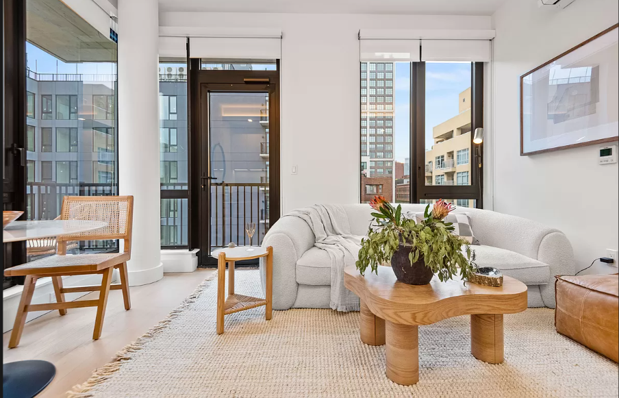 a living room with furniture and a potted plant