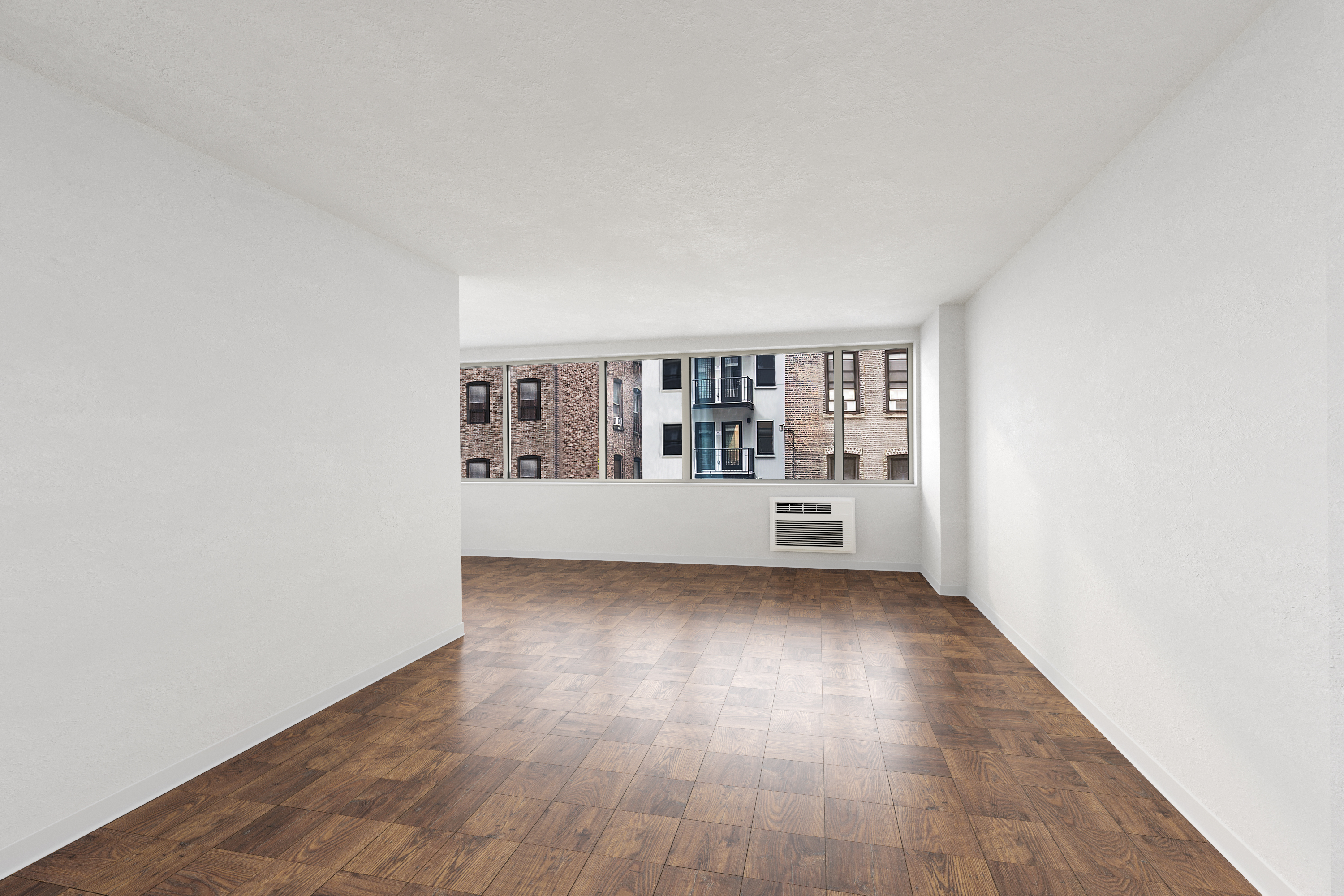 a view of a big room with wooden floor and windows