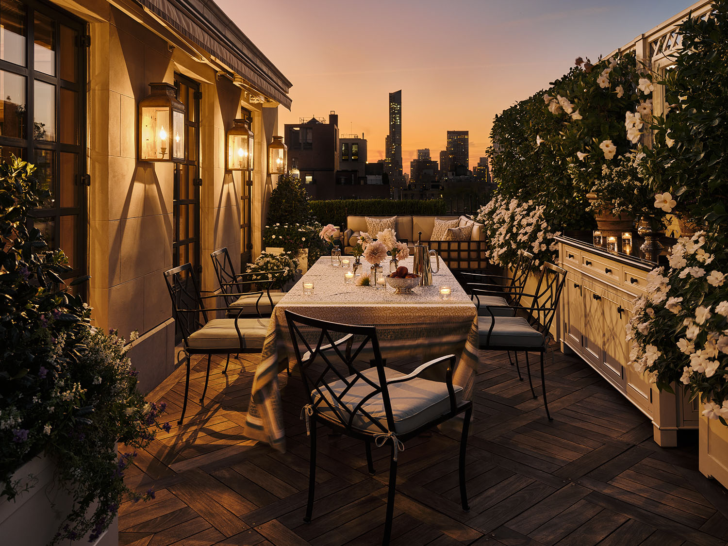 a view of a patio with table and chairs and potted plants with wooden floor and fence