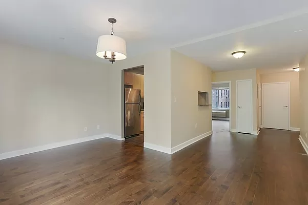 a view of a room with wooden floor