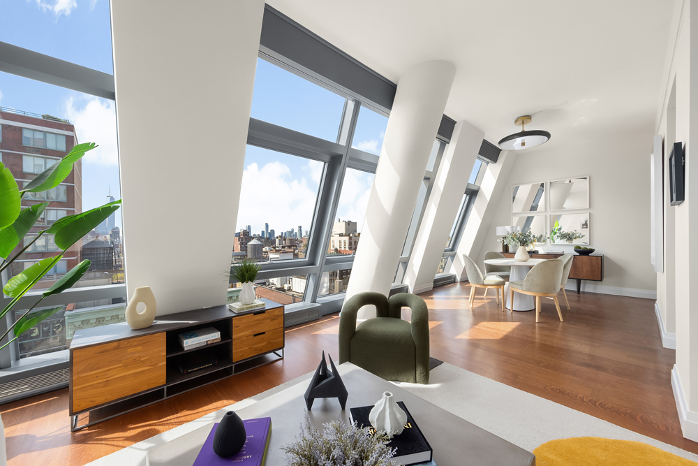 a living room with furniture wooden floor and a floor to ceiling window