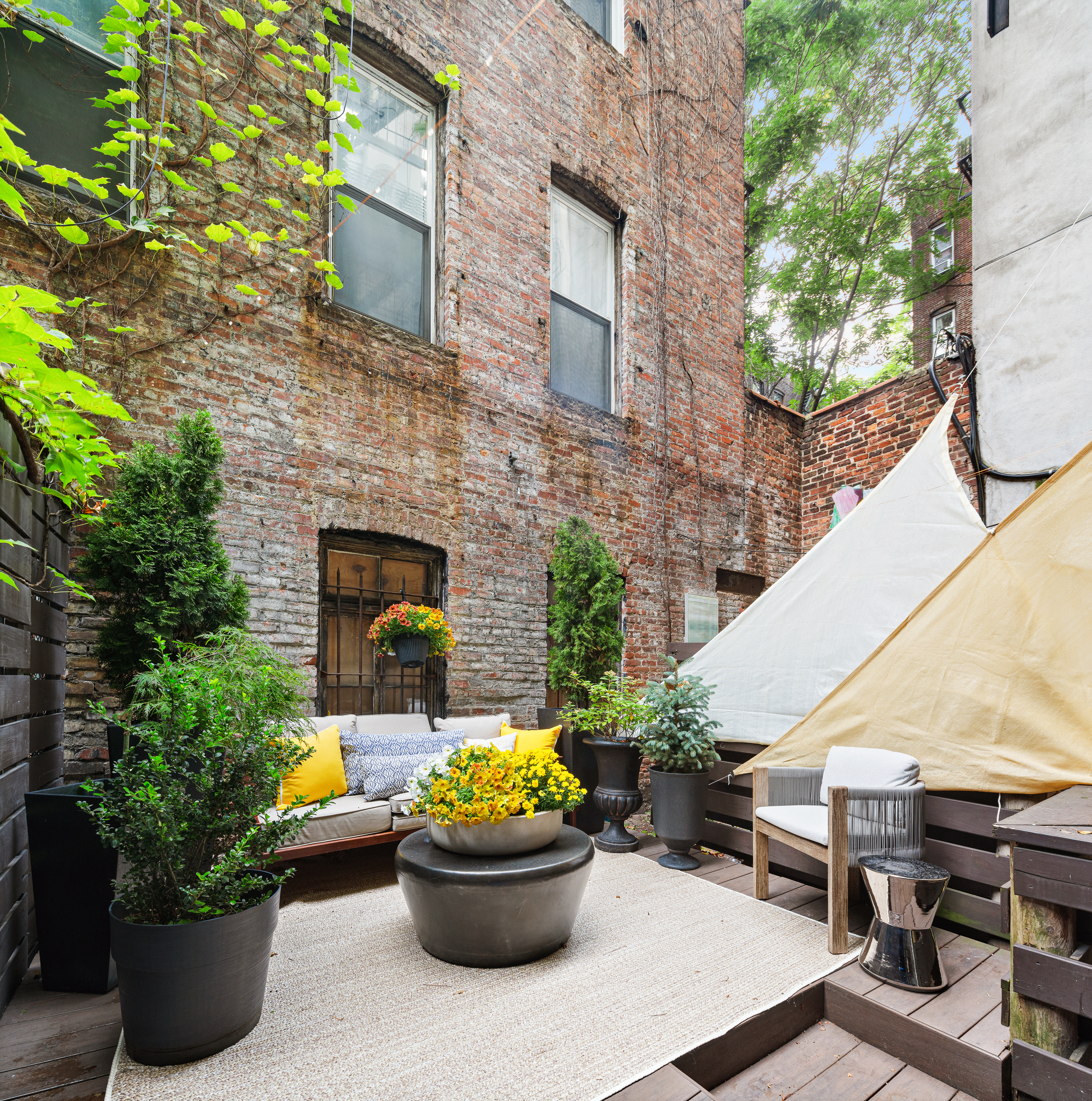 a view of a patio with couches and potted plants