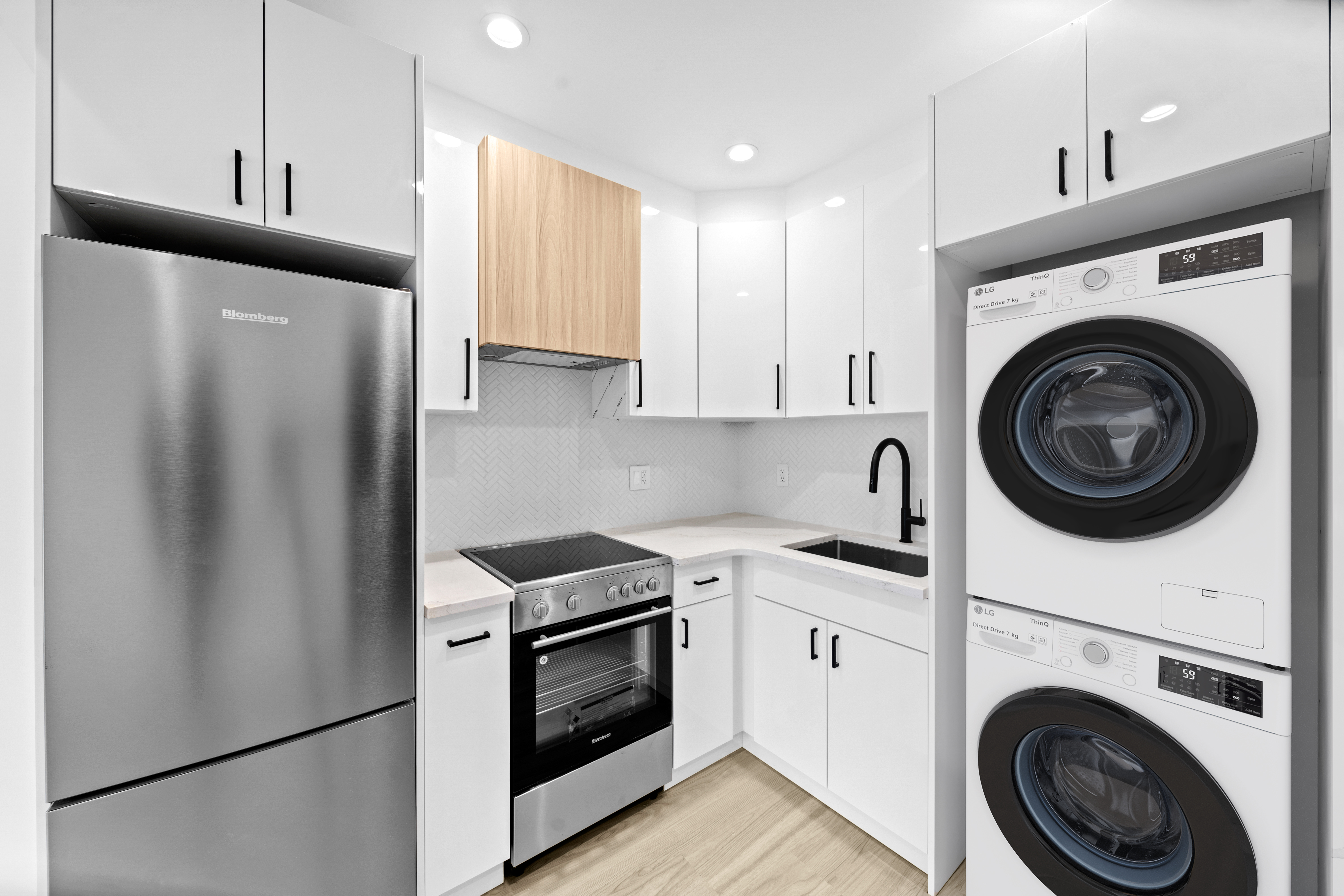 a kitchen with stainless steel appliances white cabinets and a refrigerator