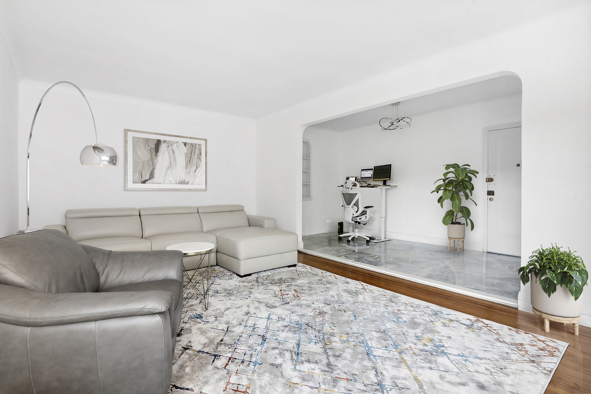 a living room with furniture and wooden floor