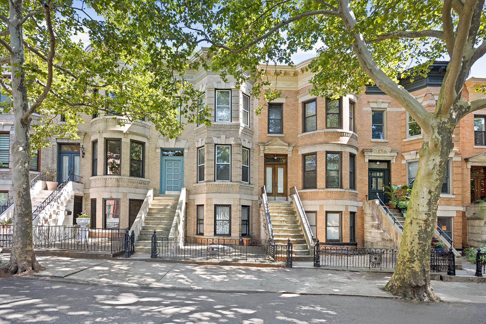 a front view of a residential apartment building with a yard