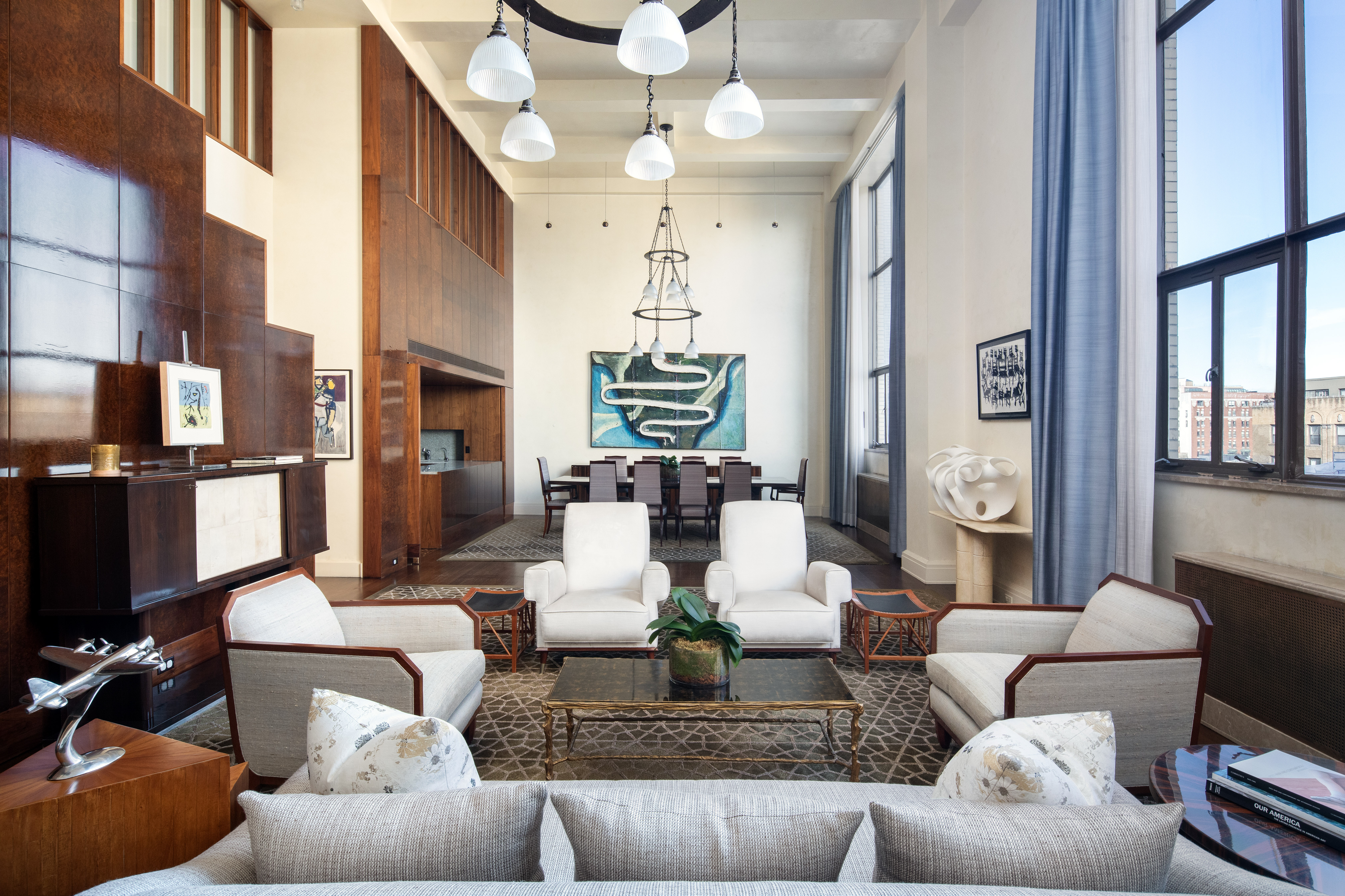 a living room with fireplace furniture and a chandelier