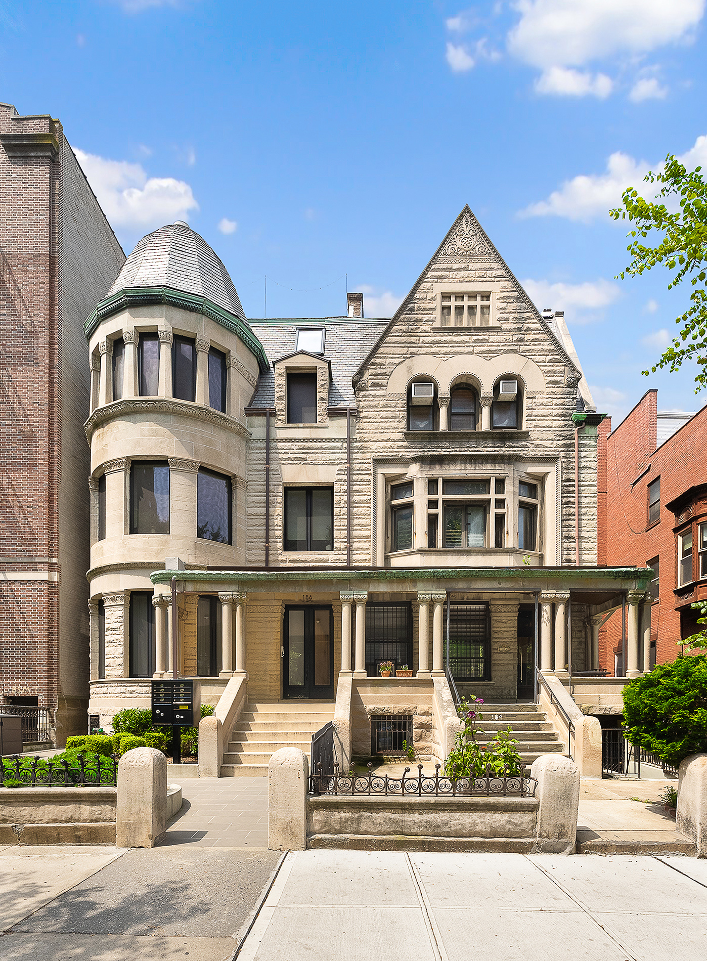 a front view of a residential apartment building with a yard