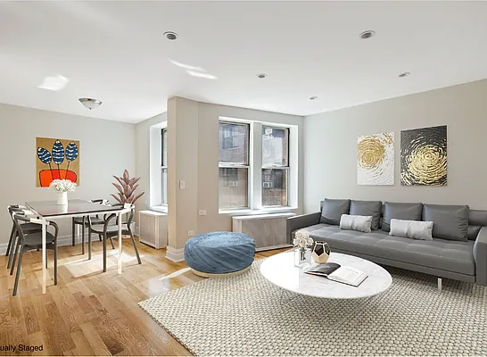 a living room with furniture a wooden floor and next to a window