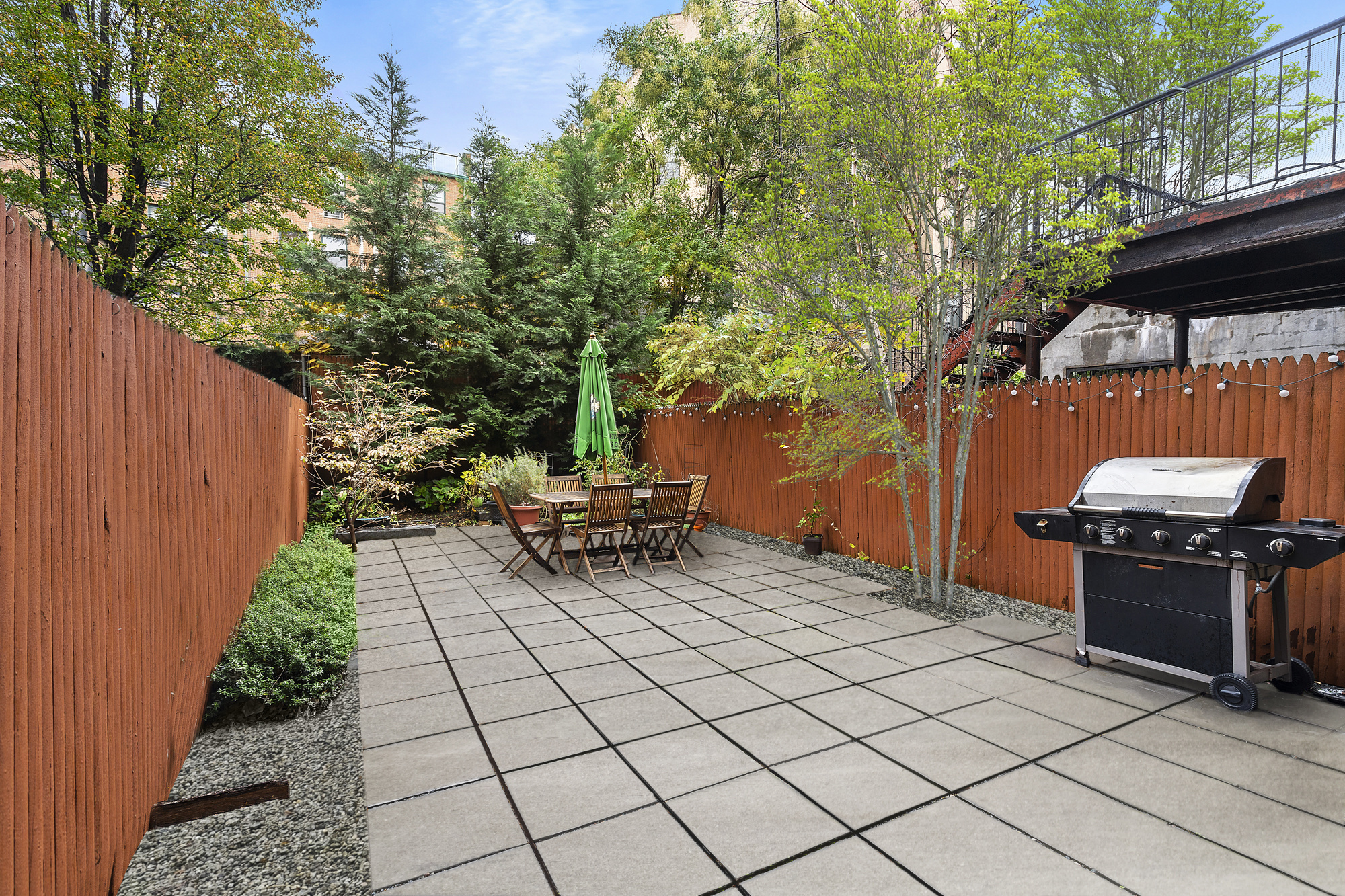 a view of a backyard with sitting area