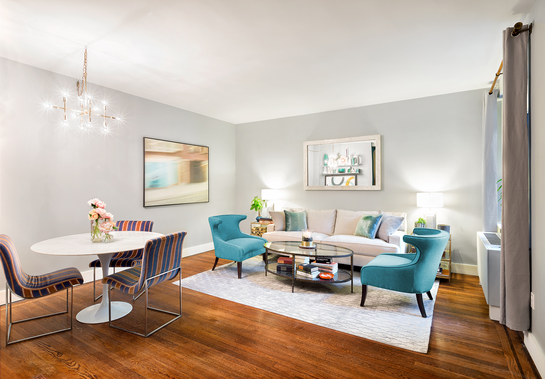 a living room with furniture and a wooden floor