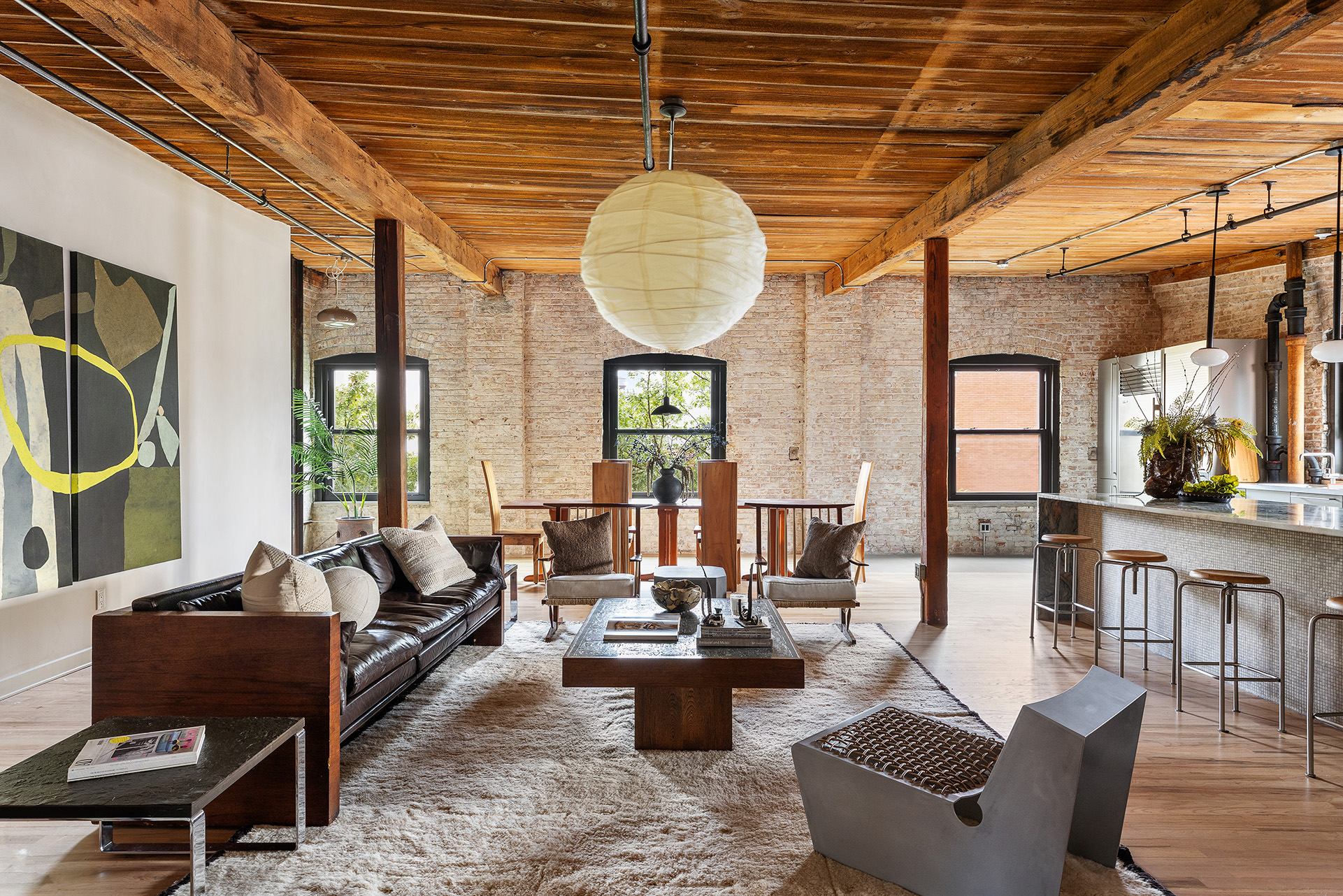 a living room with furniture a chandelier and a window