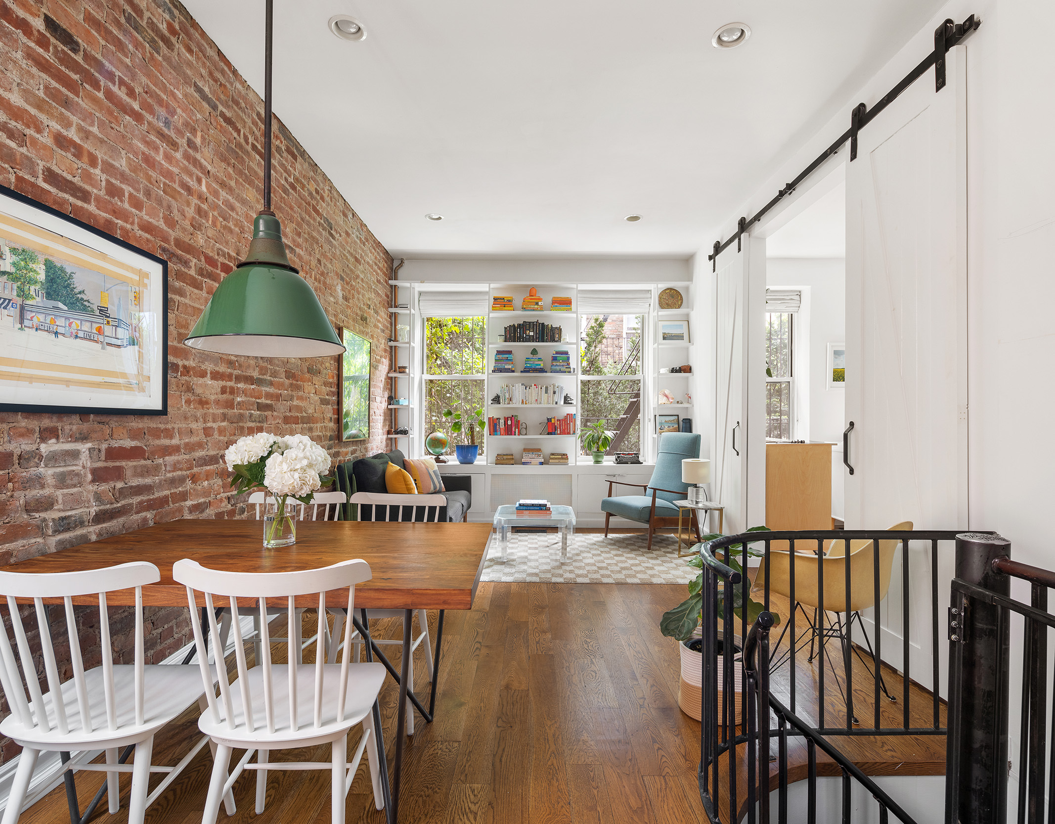 a dining room with furniture a window and wooden floor