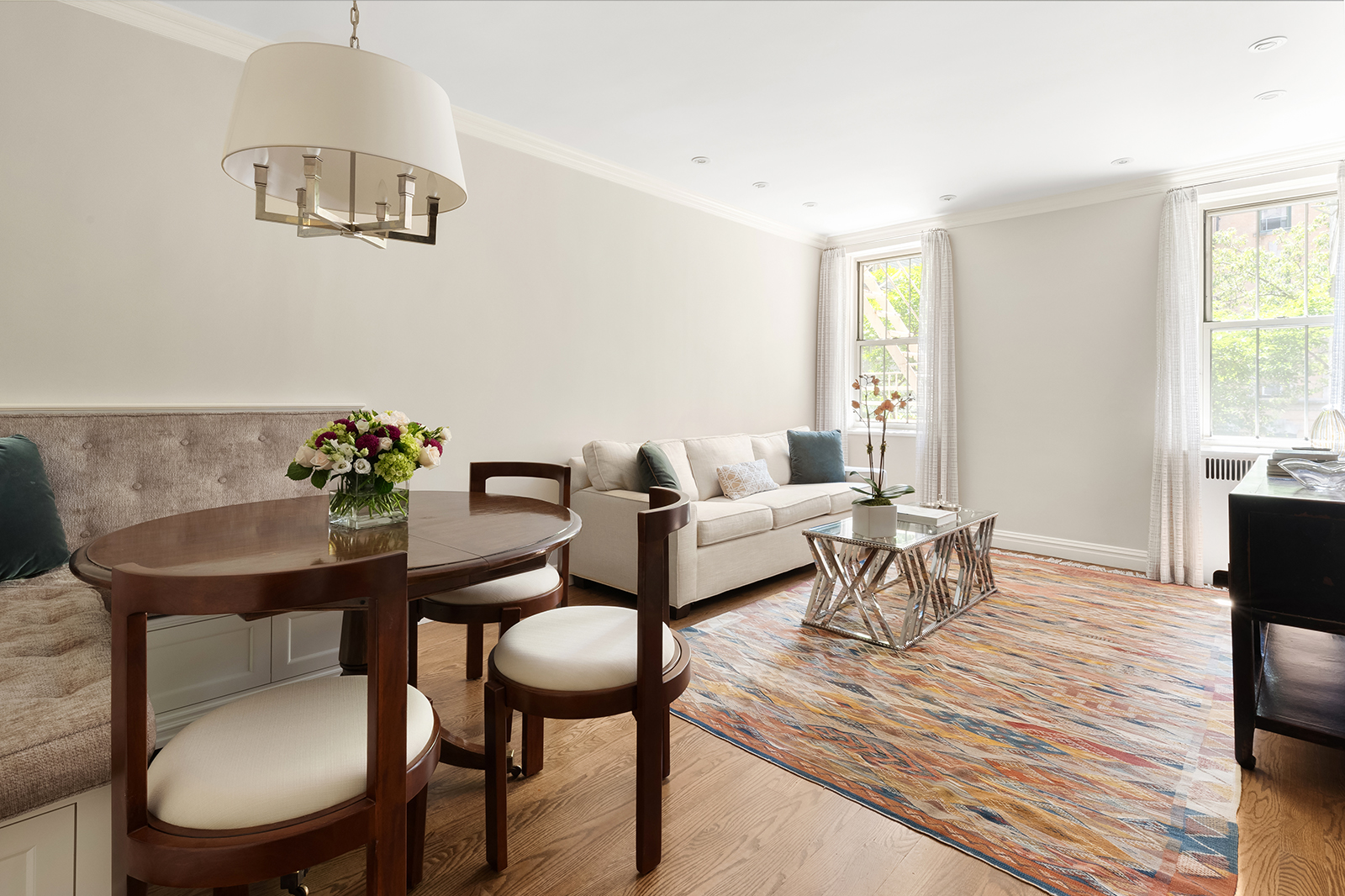 a living room with furniture a rug and a window