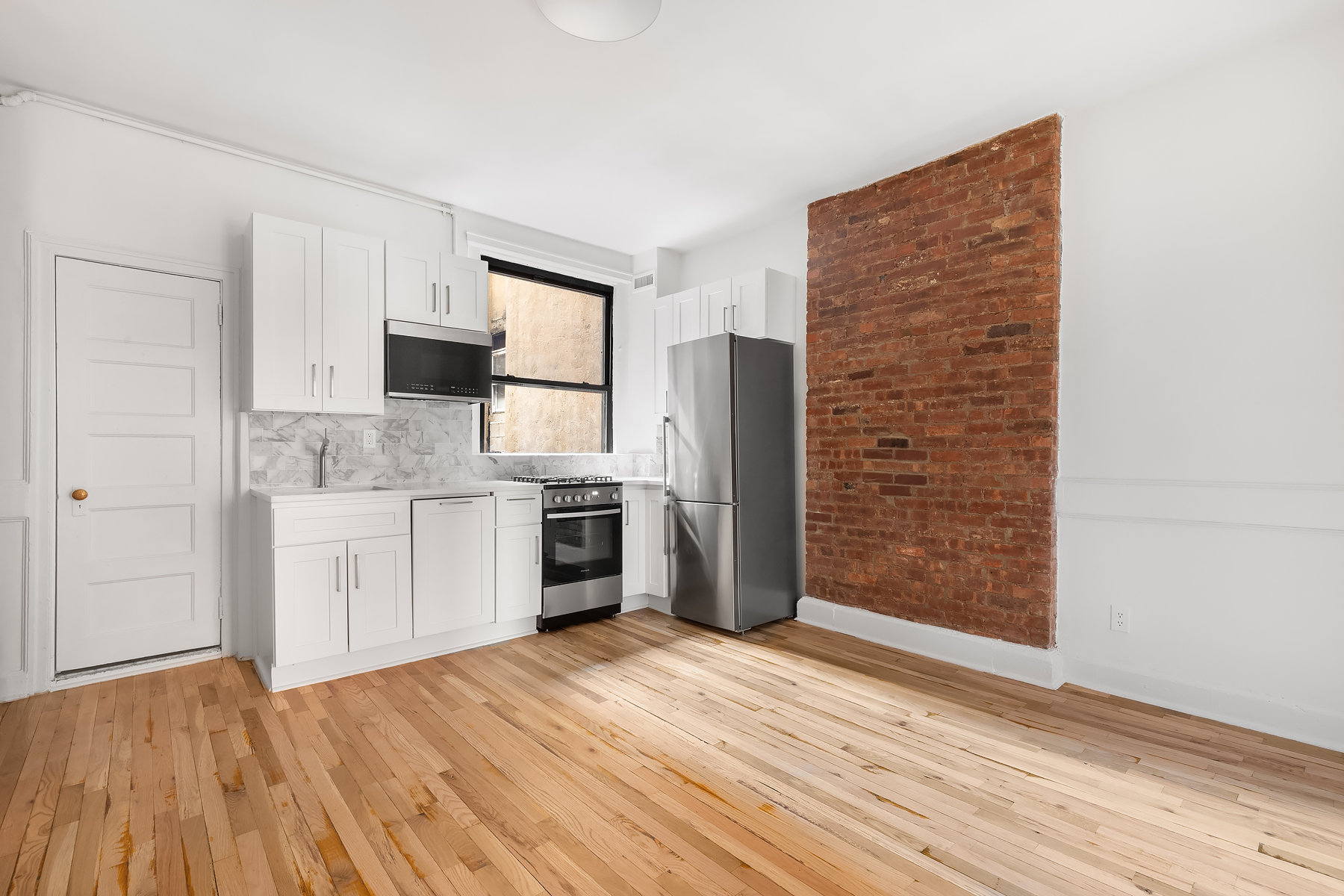 a kitchen with stainless steel appliances a refrigerator and a stove top oven