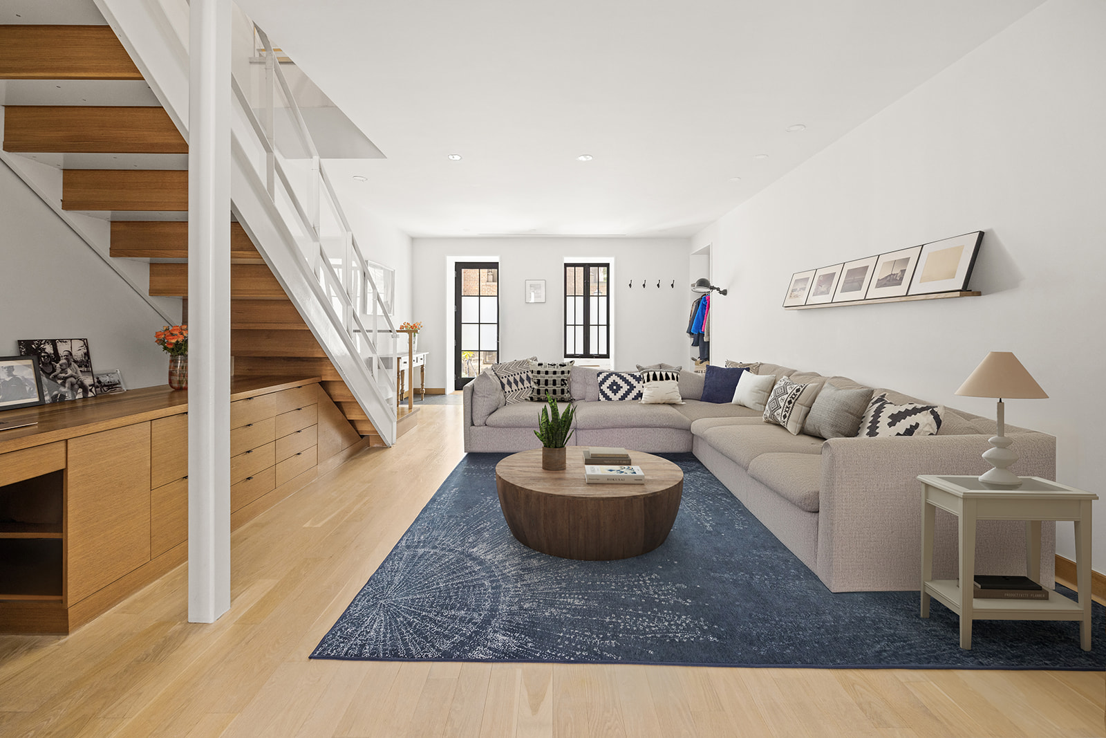 a living room with furniture and a wooden floor