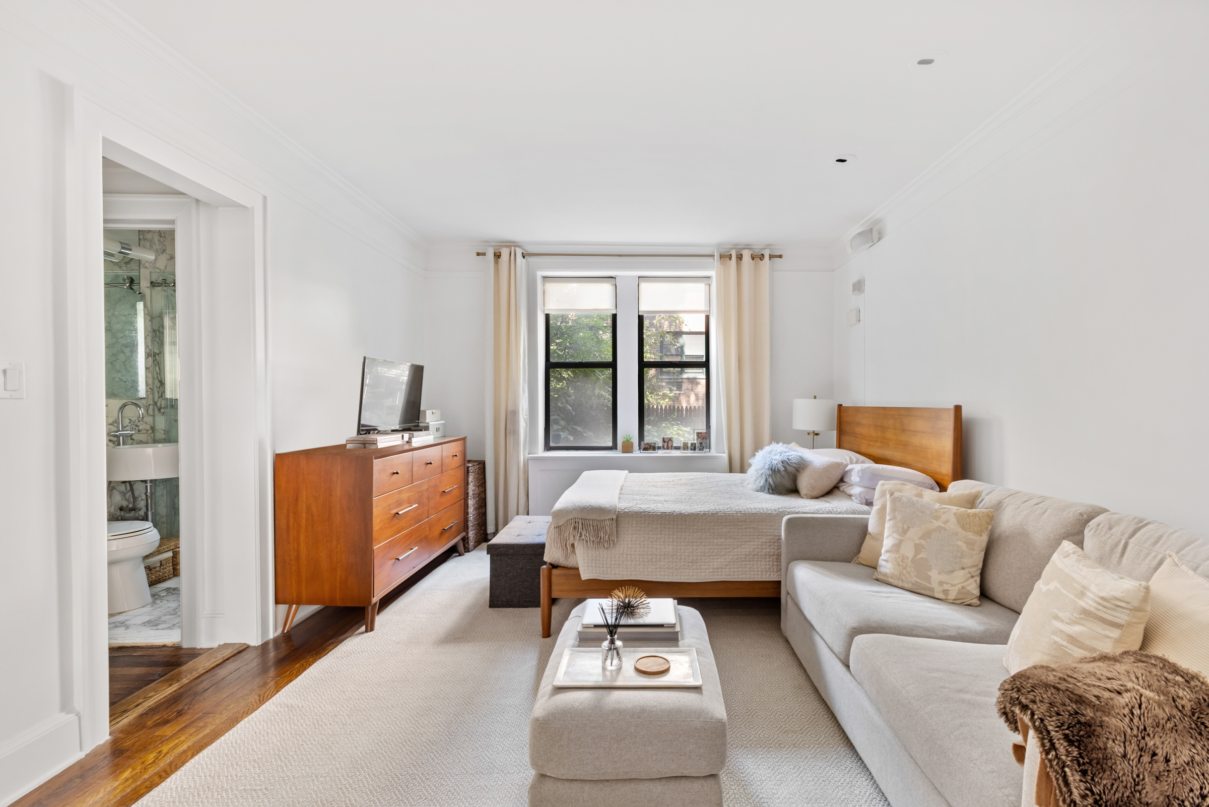 a bedroom with furniture and a window