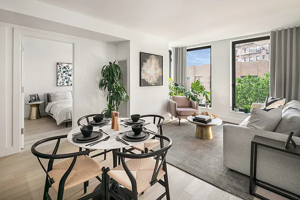 a living room with furniture a window and a potted plant